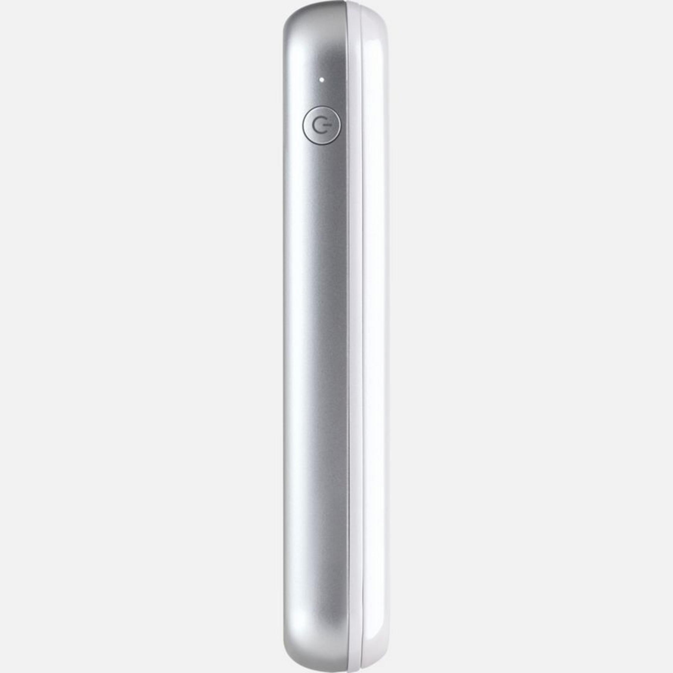 Srebrny power bank z przyciskiem zasilania i białą stroną.