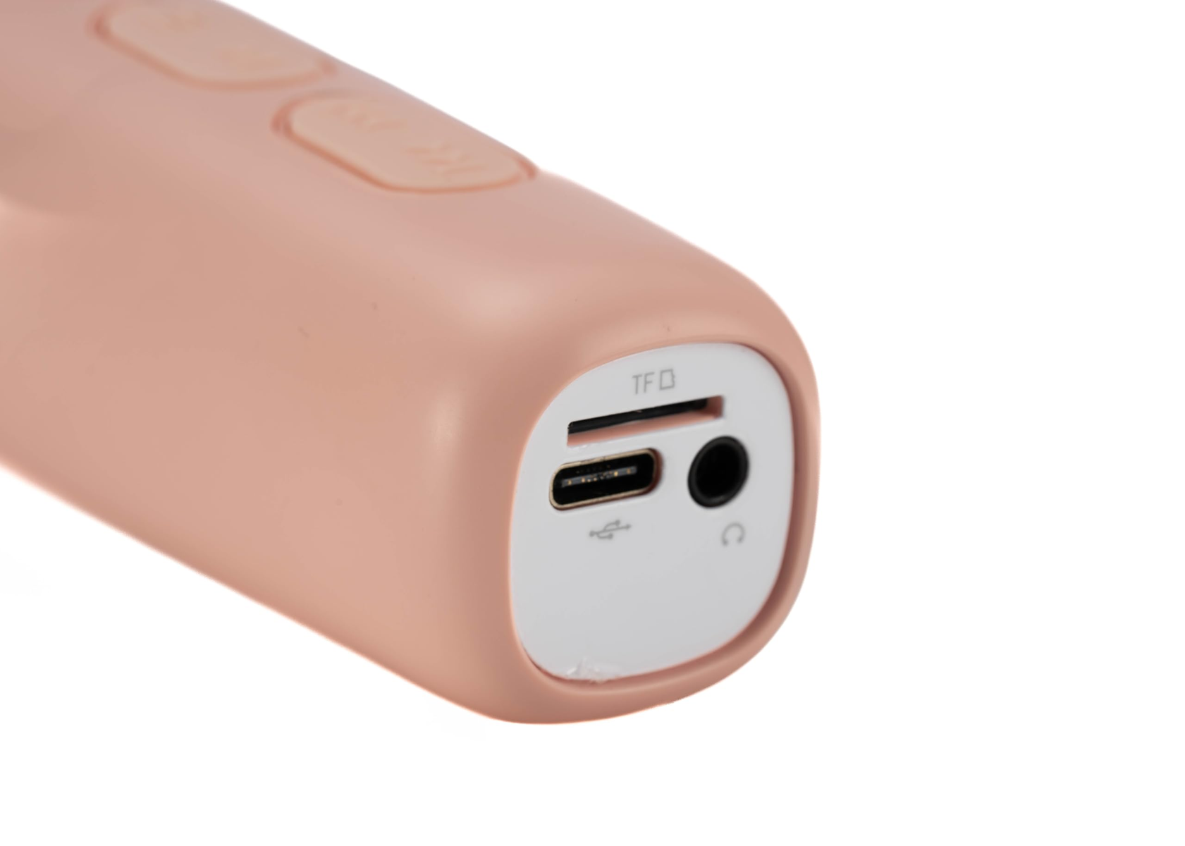 Primer plano de un dispositivo rosa con puertos USB, TF y auriculares, sobre un fondo blanco.