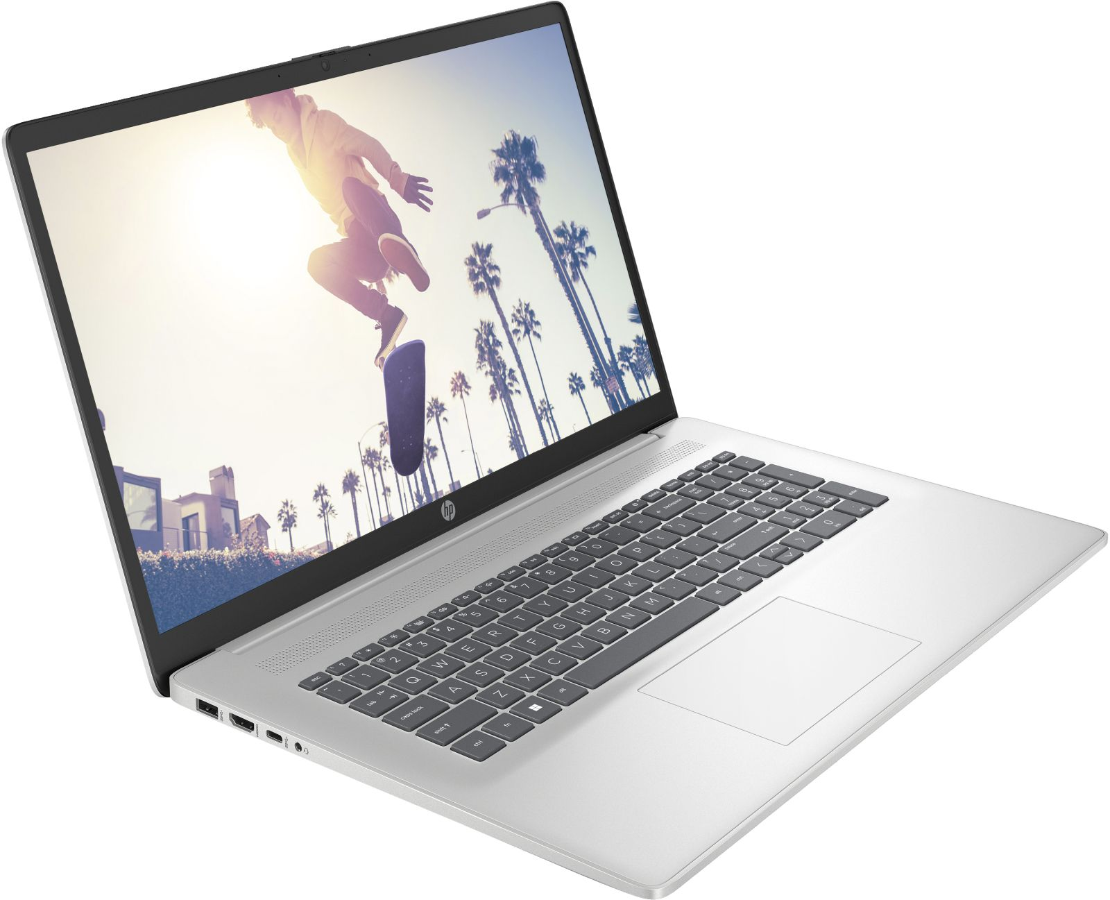 Silberner Laptop mit einer Person, die auf dem Bildschirm skatet. Palmen im Hintergrund.