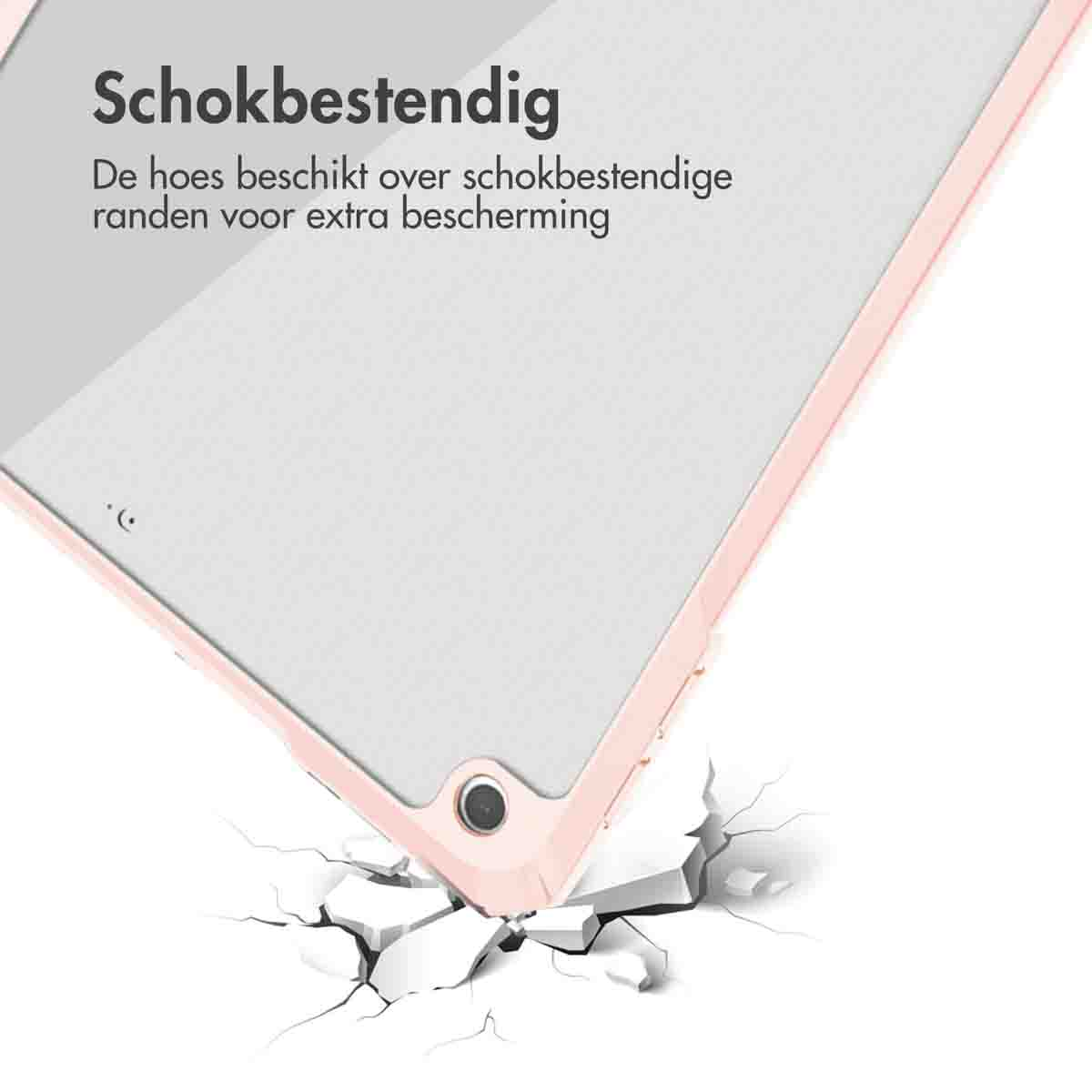Tablet case corner breaking a surface. The case is pink, and the surface is white.