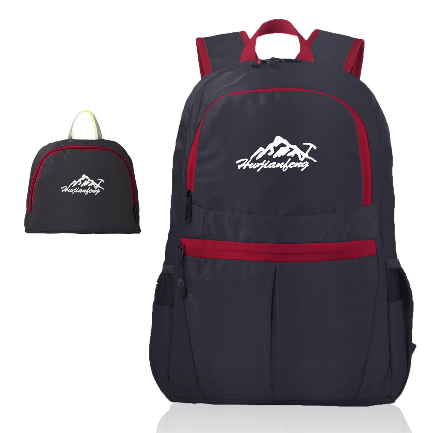 Schwarzer und grauer Rucksack mit roten Akzenten. Weißes Berglogo. Eine kleine Tasche mit demselben Logo.