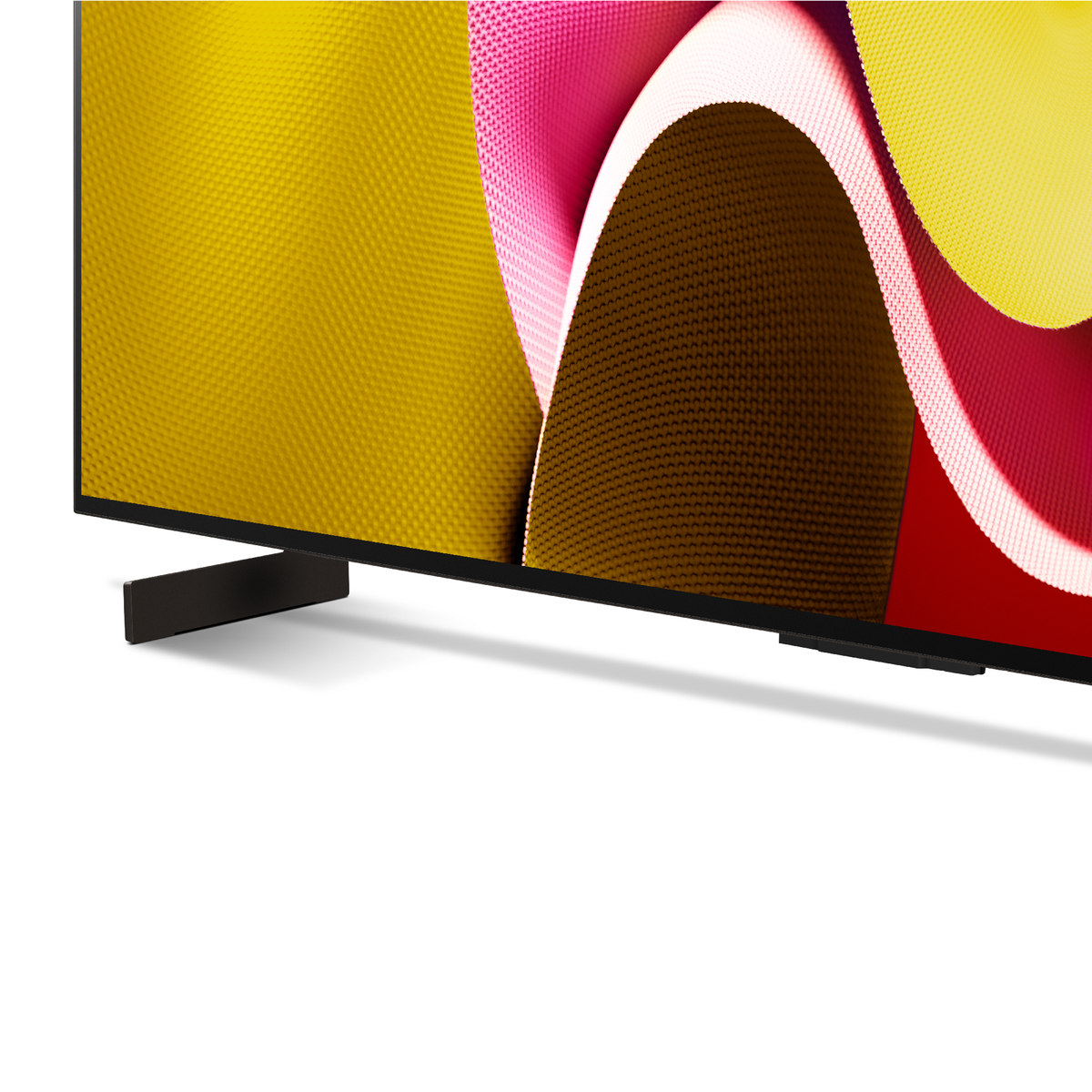 Close-up van een tv-scherm met een zwart frame. Het scherm toont een abstract kleurrijk beeld.