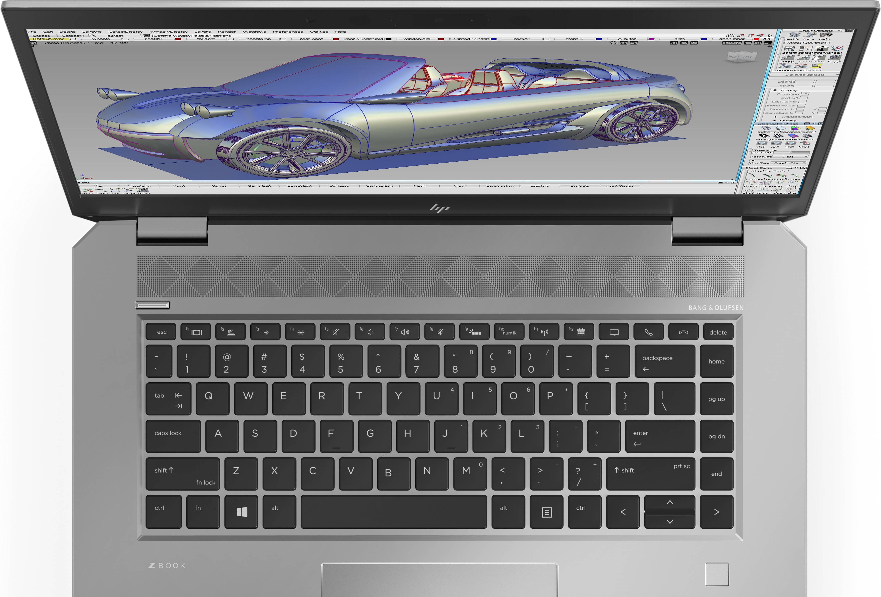 Laptop with open screen, showing a 3D car design. Silver keyboard, white background.