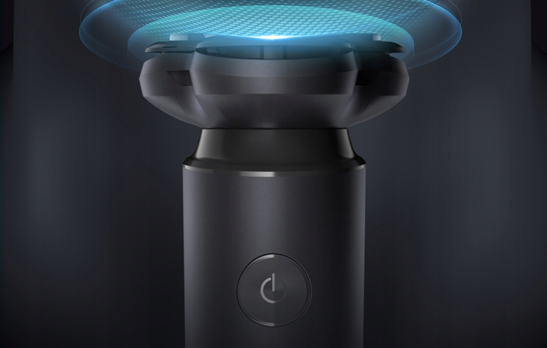 Primer plano de un cabezal de afeitadora negro con un botón de encendido. Luz azul alrededor de la parte superior.