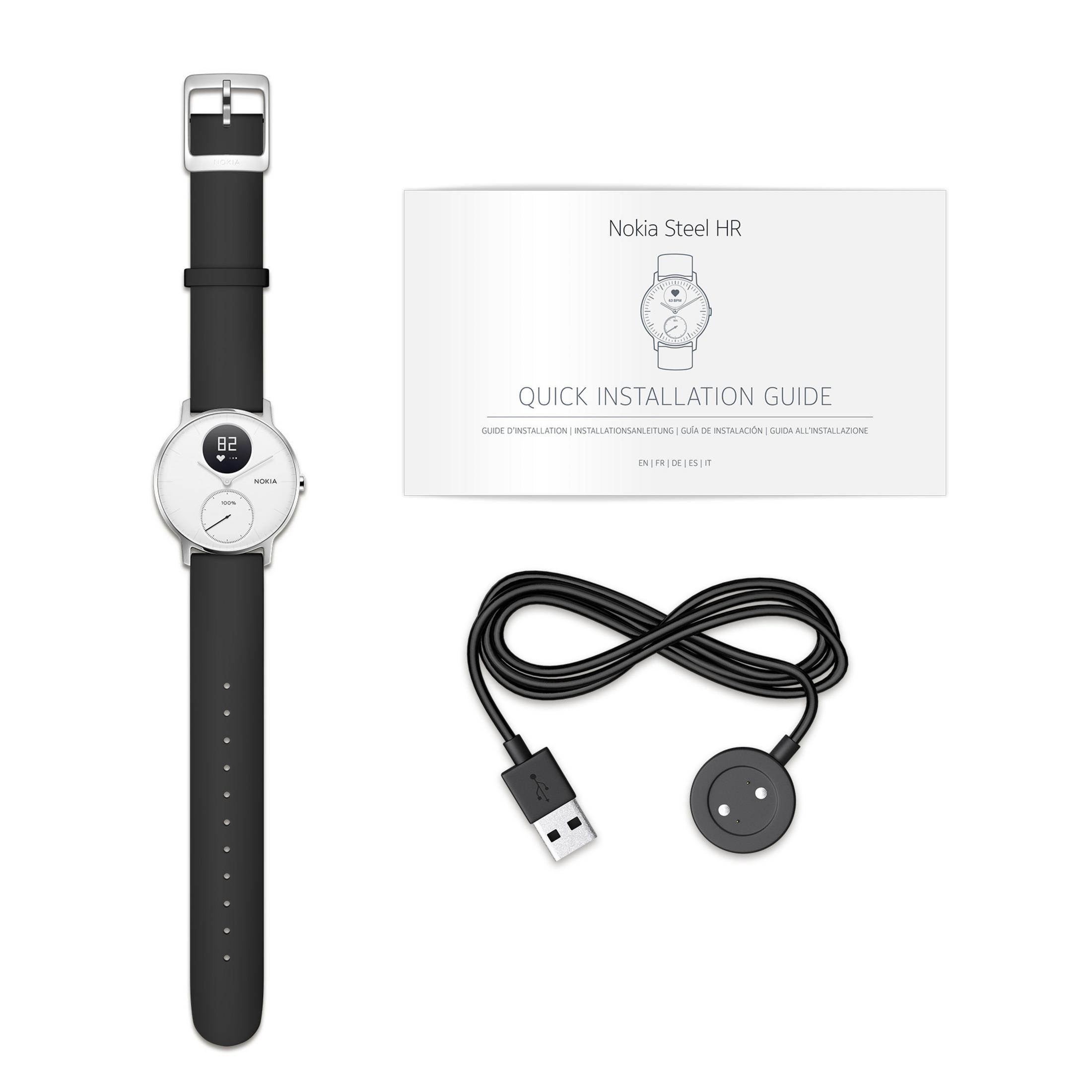 Weiße Uhr mit schwarzem Armband, USB-Kabel und Kurzanleitung auf weißer Oberfläche.