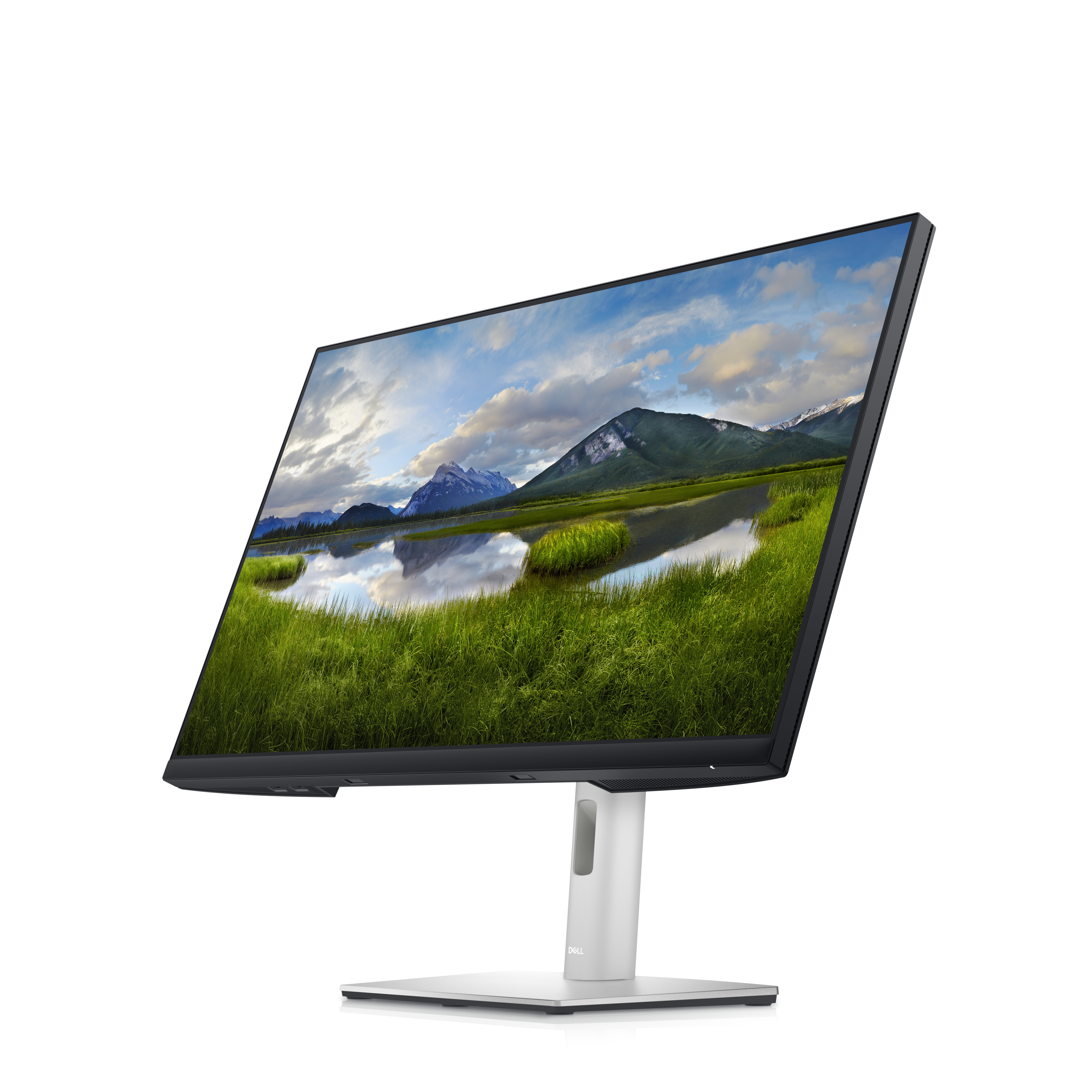 Un monitor de computadora que muestra un paisaje de hierba verde, agua, montañas y cielo azul.