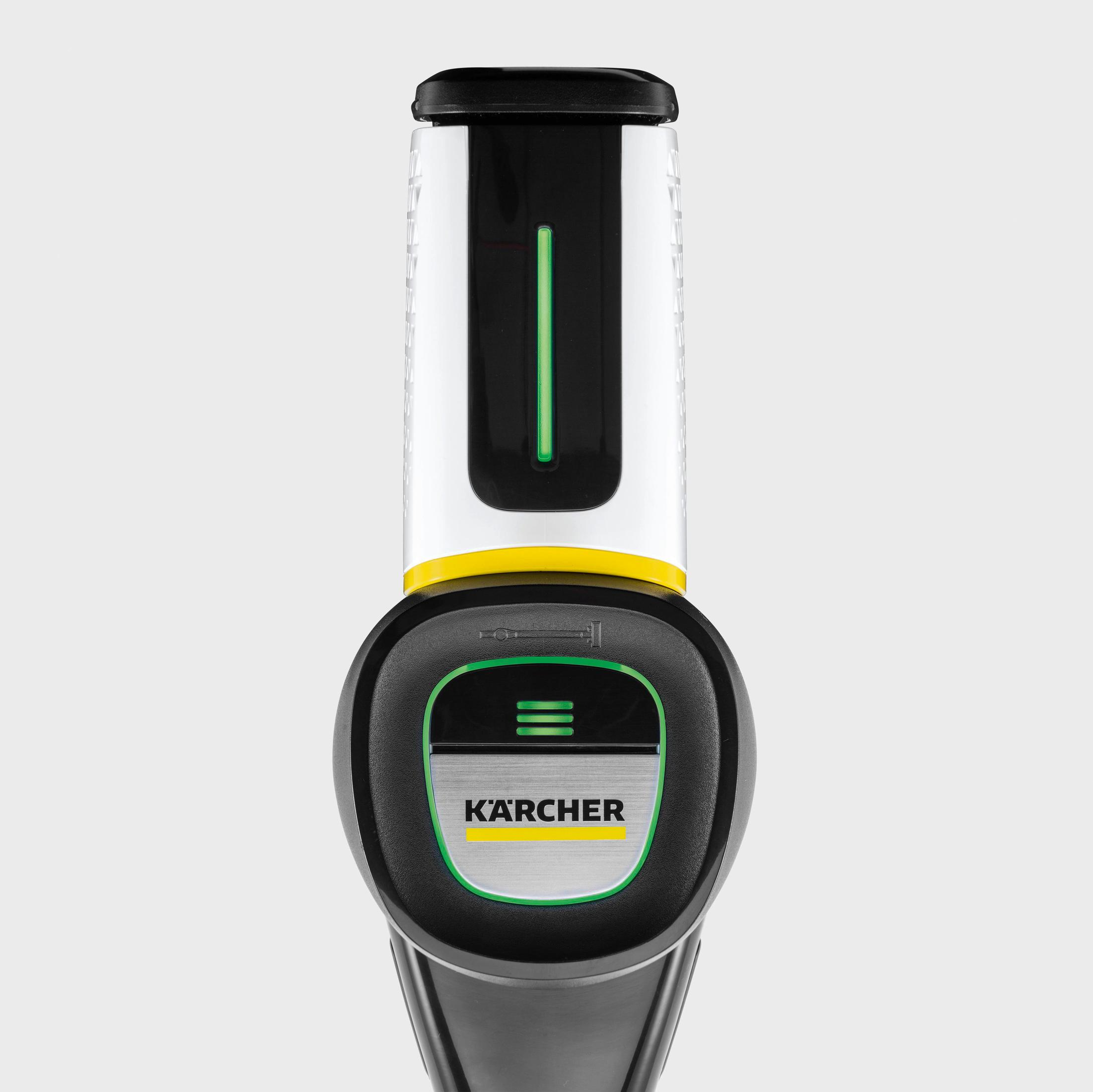 Un aspirateur à main, noir et blanc, avec une bande verte et des boutons. Le logo Karcher est dessus.