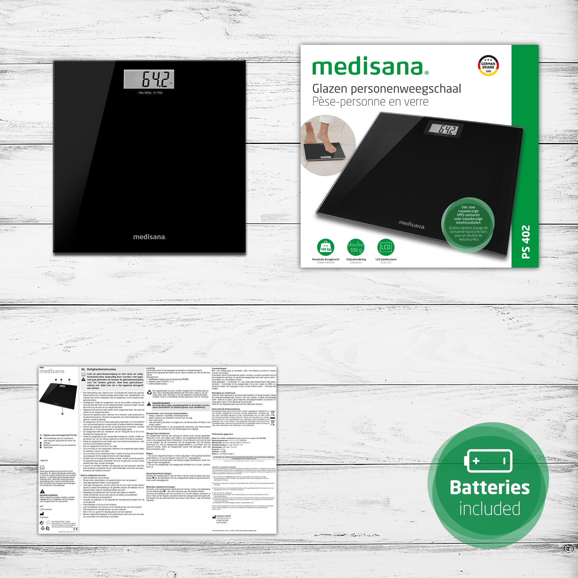 Black digital bathroom scale with display showing 64.2, next to its box on a white wood background.