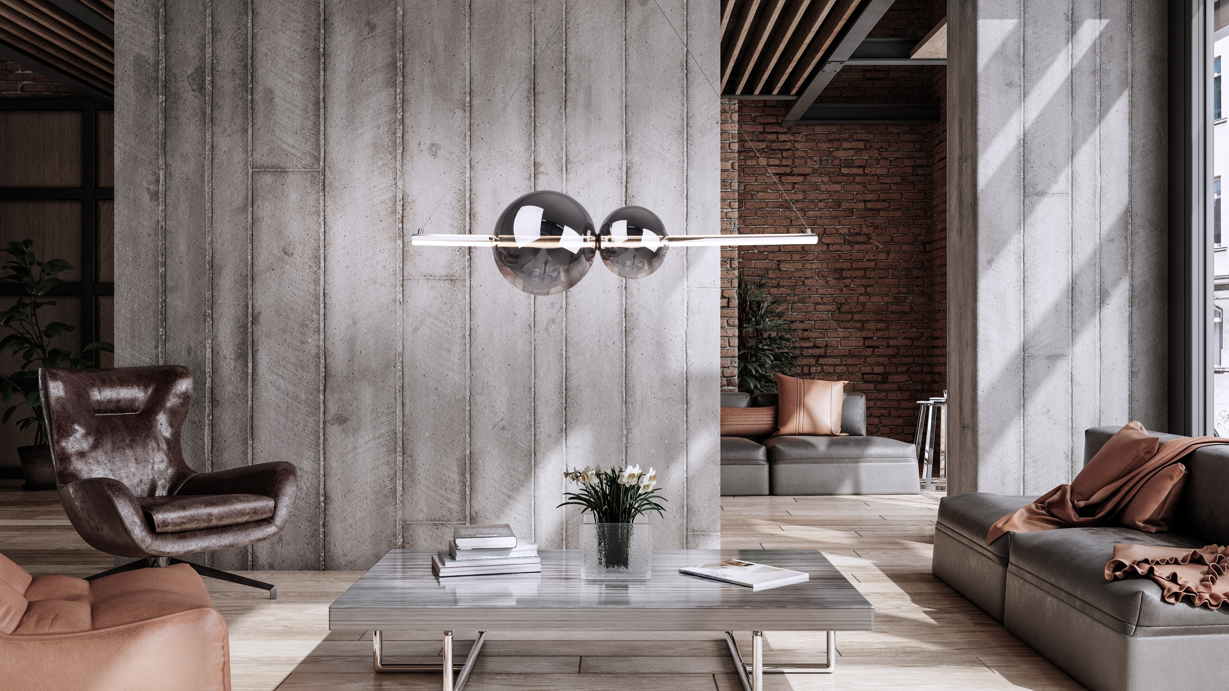 Salon moderne avec un mur en béton, un canapé gris et un luminaire sphérique. Une table basse devant.