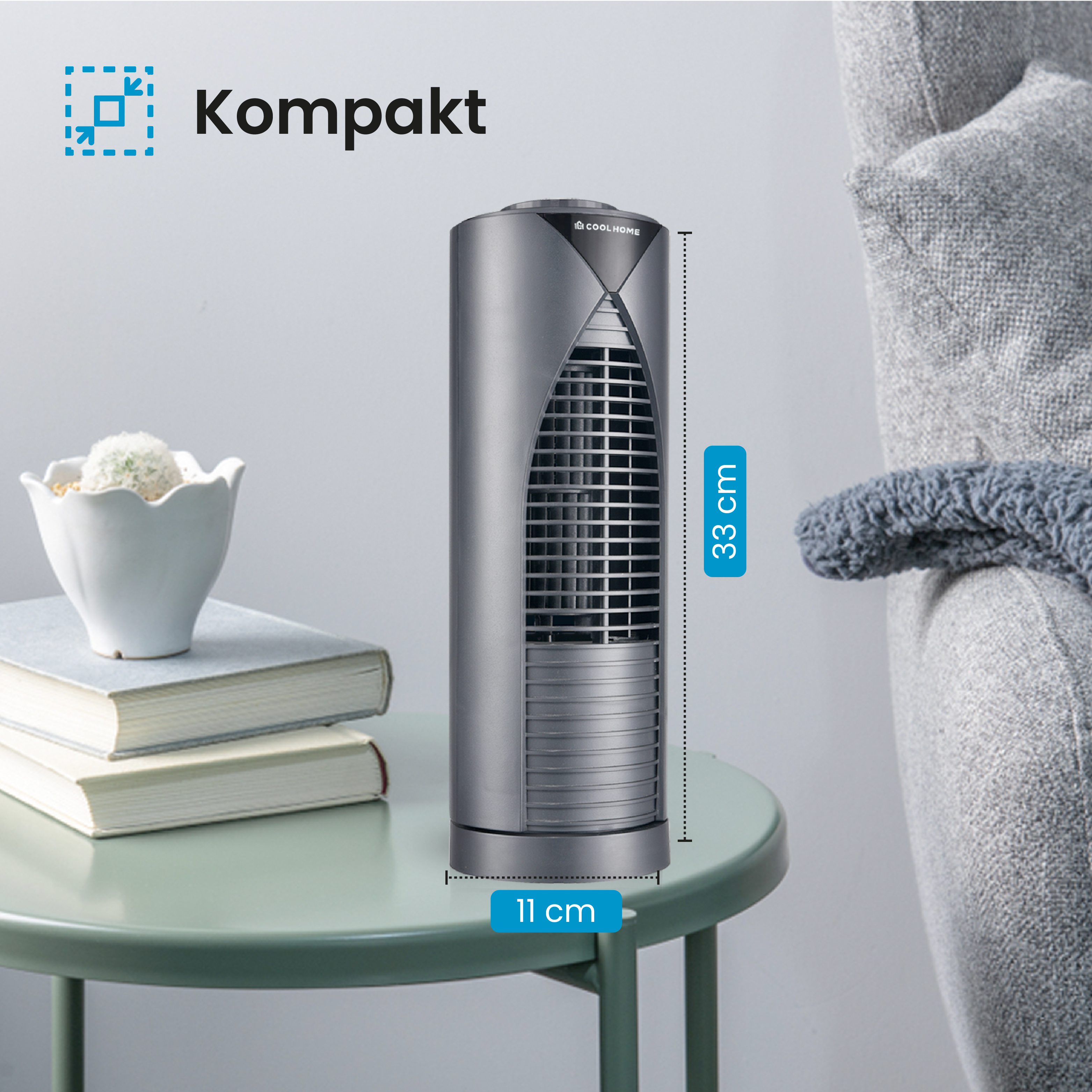 Grauer, kompakter Ventilator auf einem grünen Tisch. Der Text lautet: „Kompakt“. Eine Höhe von 33 cm und eine Breite von 11 cm sind angegeben.
