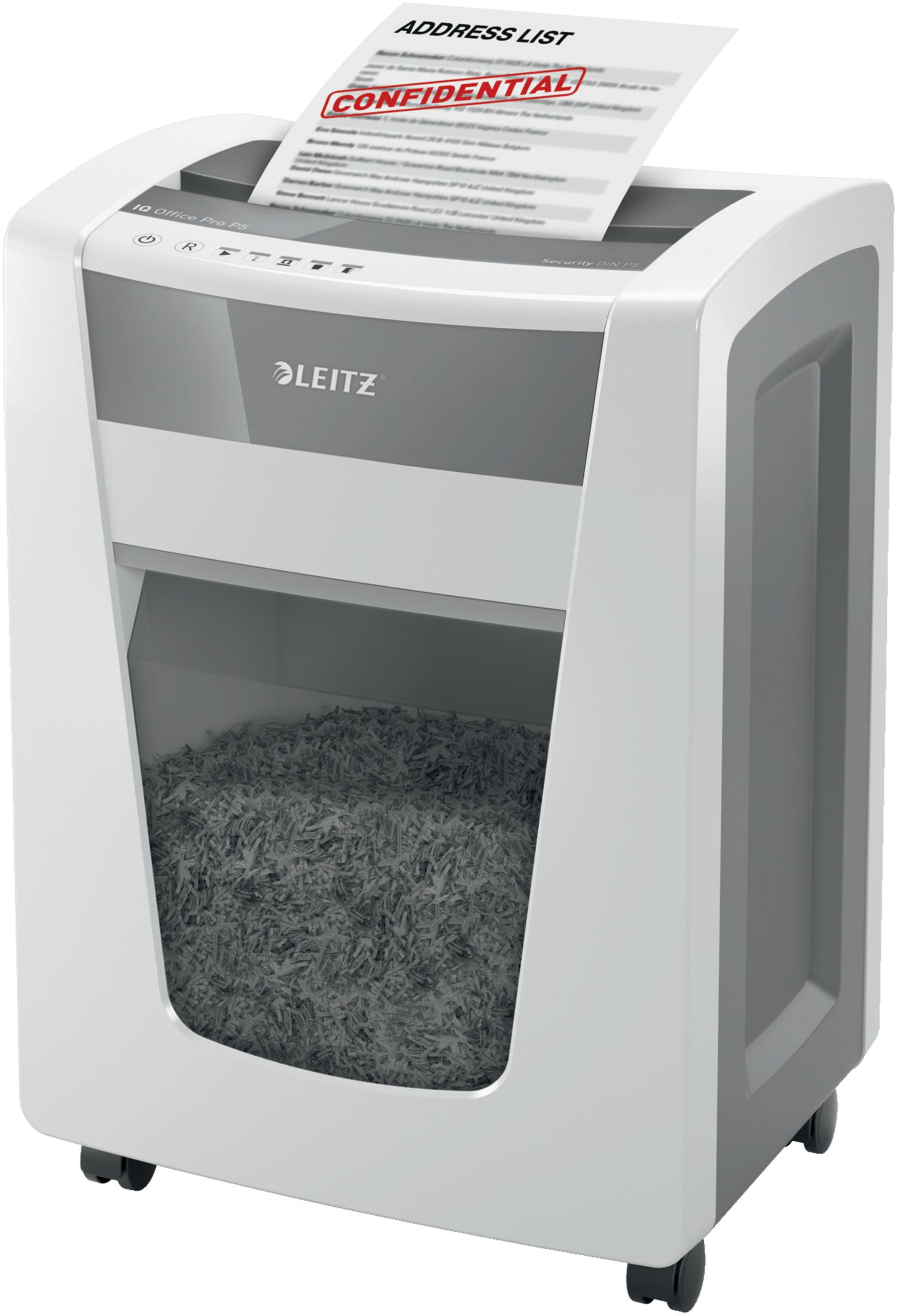 Biała i szara niszczarka do papieru z widocznym pociętym papierem. Niszczony jest poufny dokument.