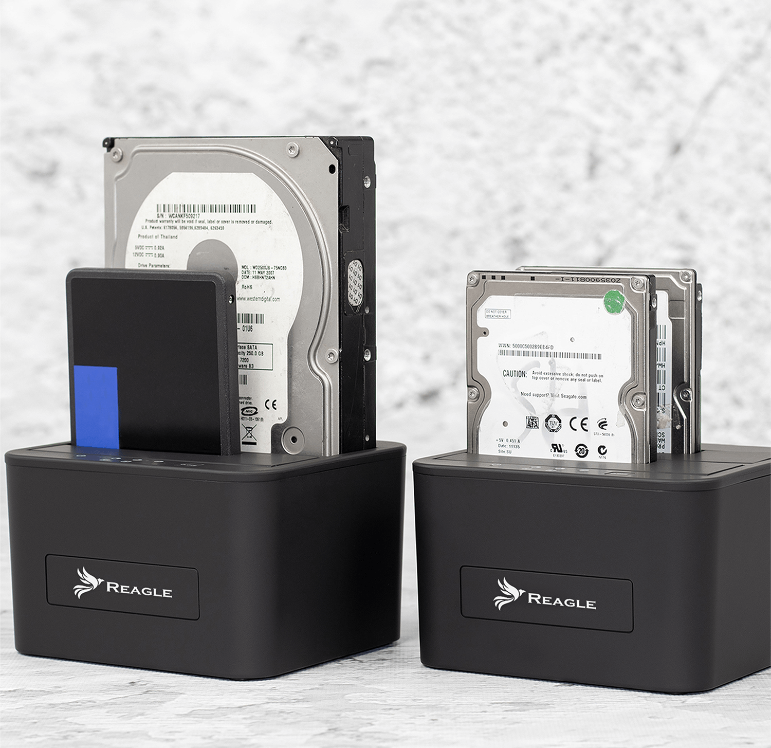 Dwie czarne stacje dokujące dysków twardych z włożonymi dyskami. Jeden ma dysk SSD.