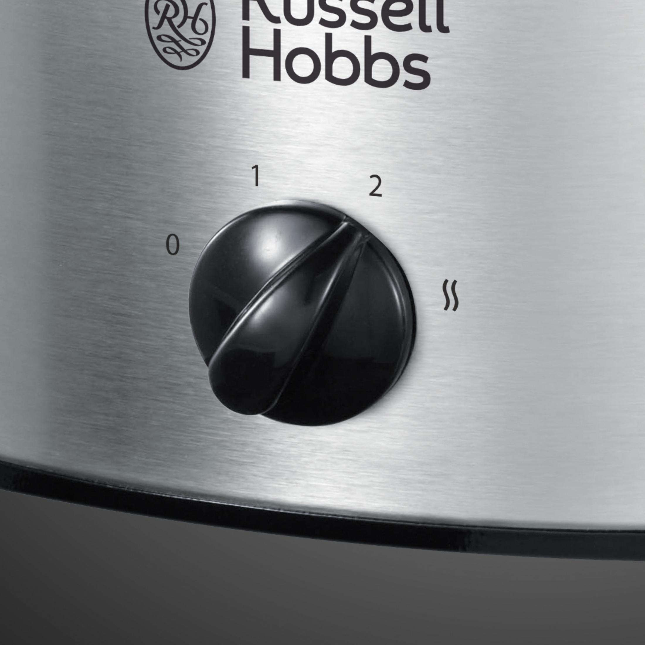 Schwarzer Drehregler an einem silbernen Slow Cooker mit den Einstellungen 0, 1, 2 und dem Heiß-Symbol.