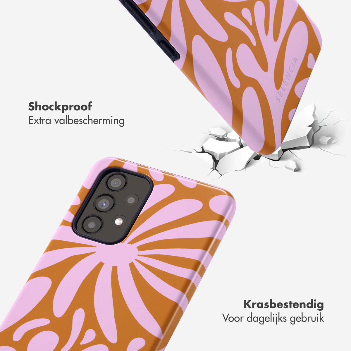 Twee telefoonhoesjes met bloemenpatroon, één valt op gebroken grond.