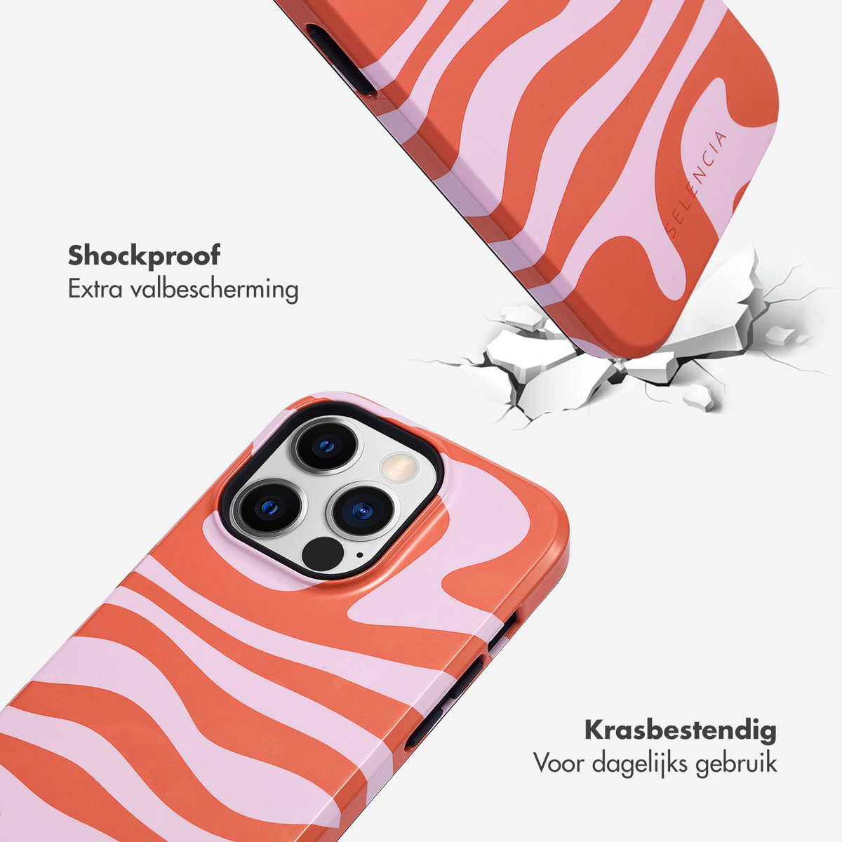 Oranje en roze golvend patroon telefoonhoes valt op gebarsten grond.