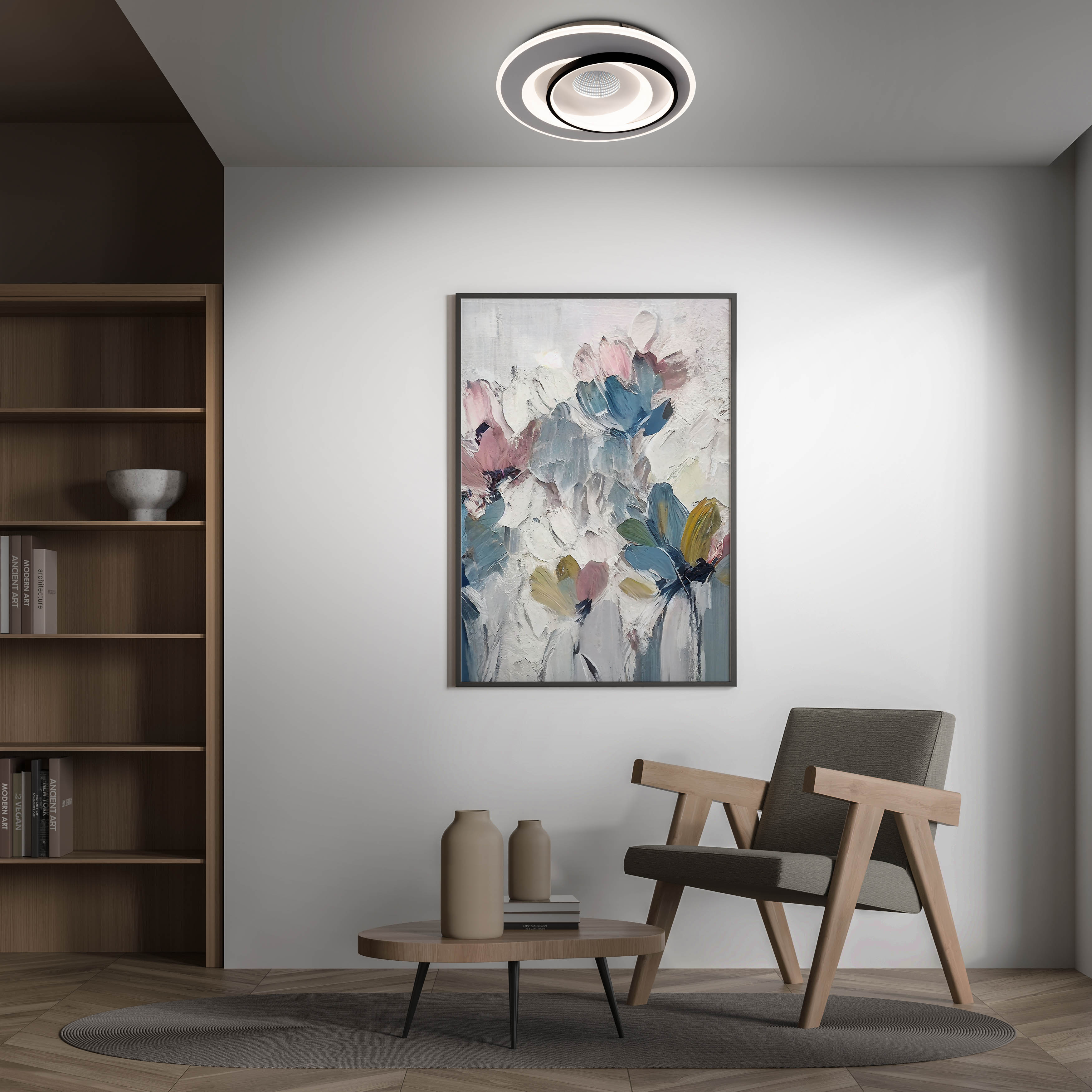 Ein modernes Wohnzimmer mit einem Gemälde, einer Deckenleuchte, einem Stuhl und einem Bücherregal.