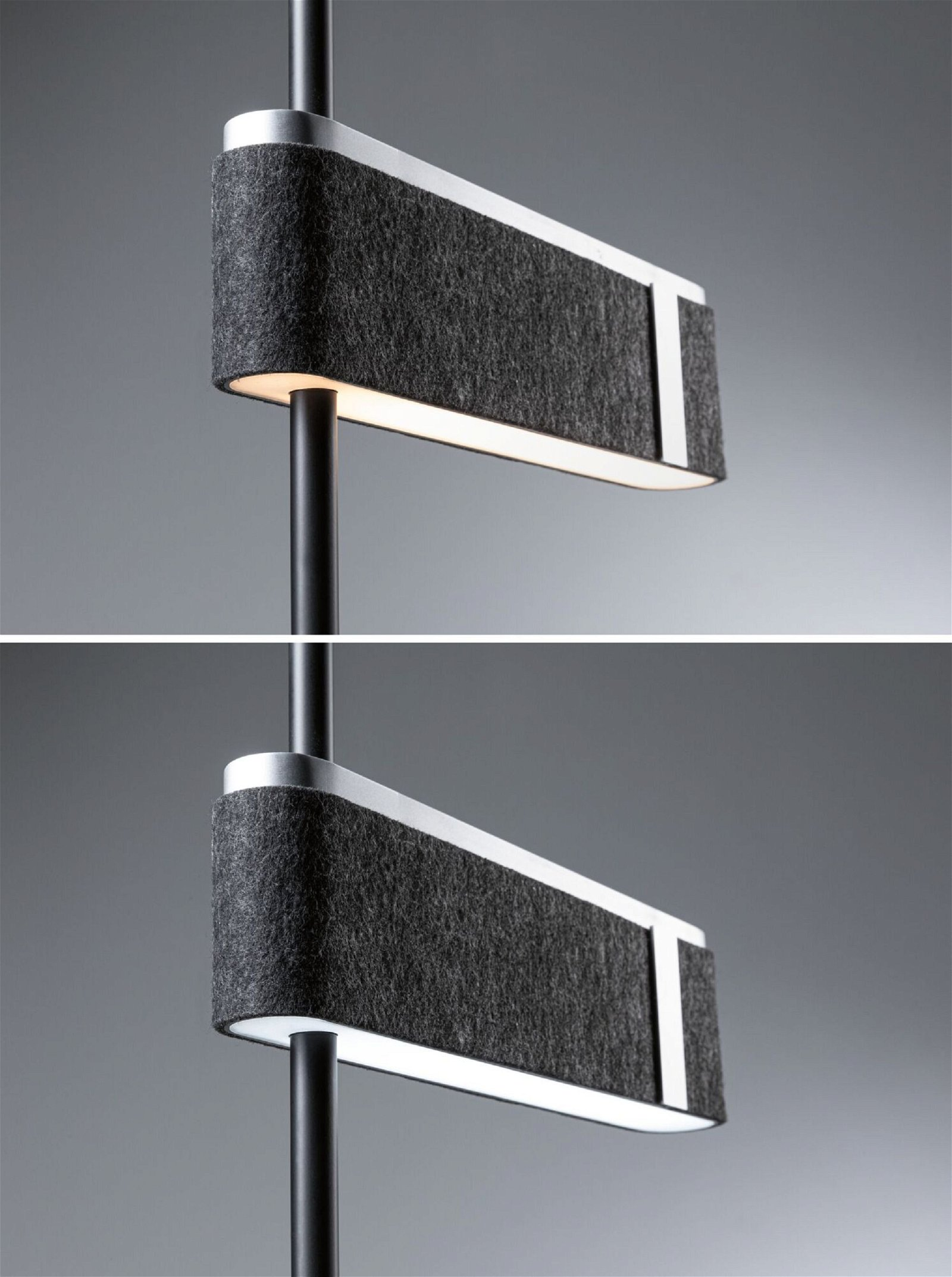 Eine Lampe mit grauem, strukturiertem Schirm, montiert an einem schwarzen Pfosten, mit weißem Licht.