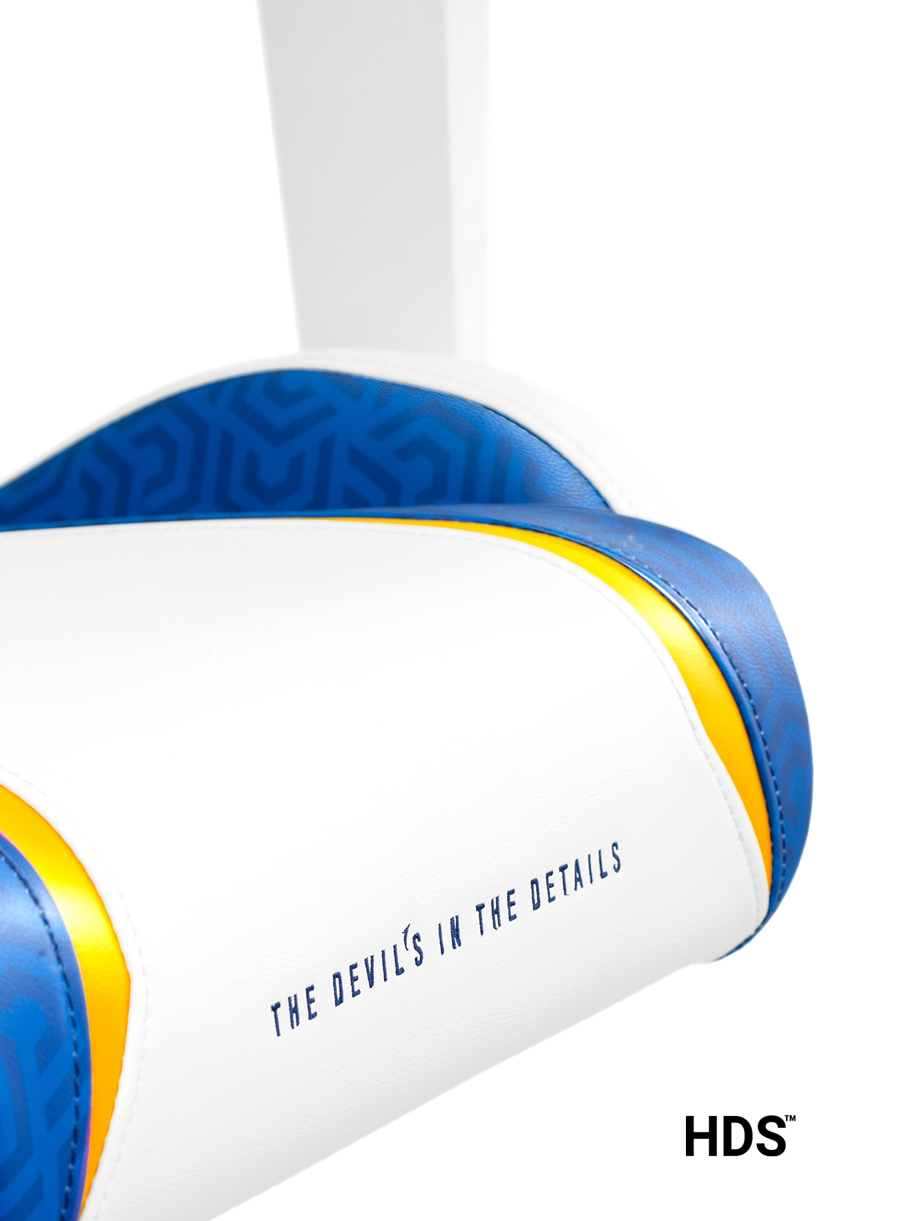 Zbliżenie białego krzesła z niebieskimi i żółtymi detalami. Tekst: 'The Devil's in the details'.