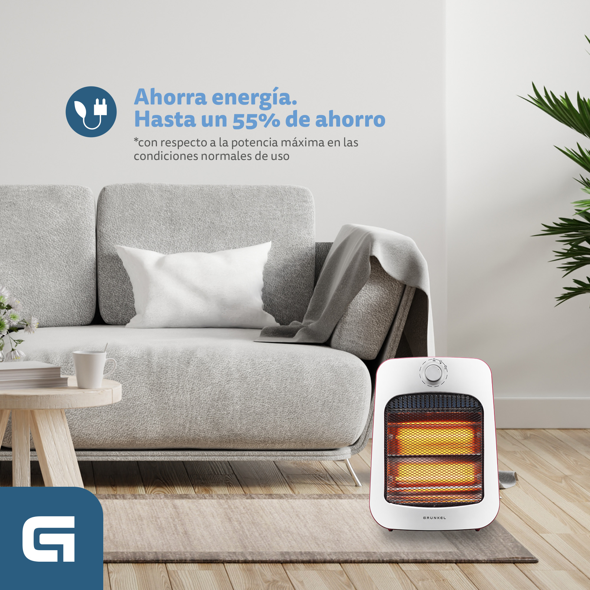 Un calefactor blanco y rojo está frente a un sofá gris. Una mesa de centro con una taza está a la izquierda.