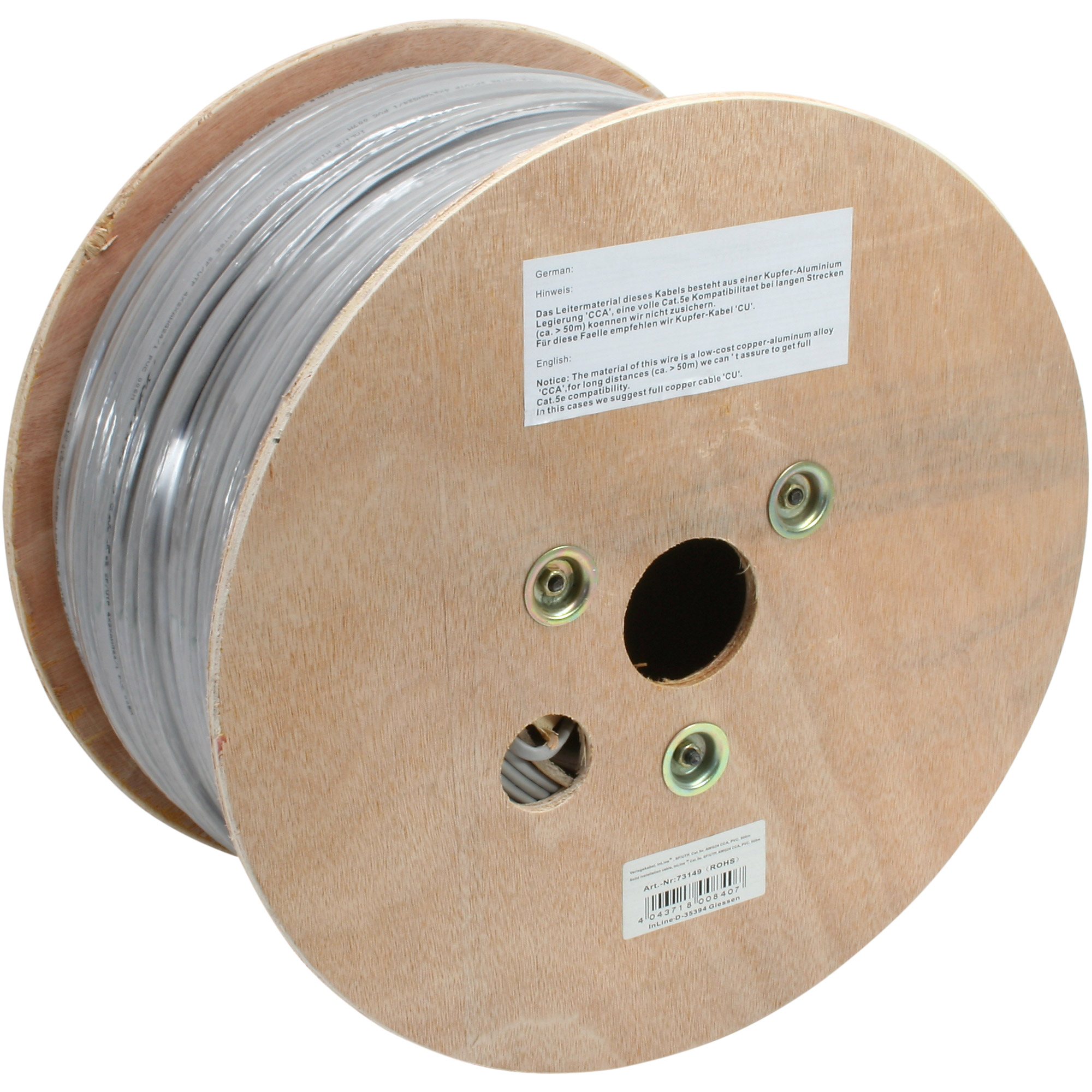 A large wooden spool of gray cable with text in German and English.