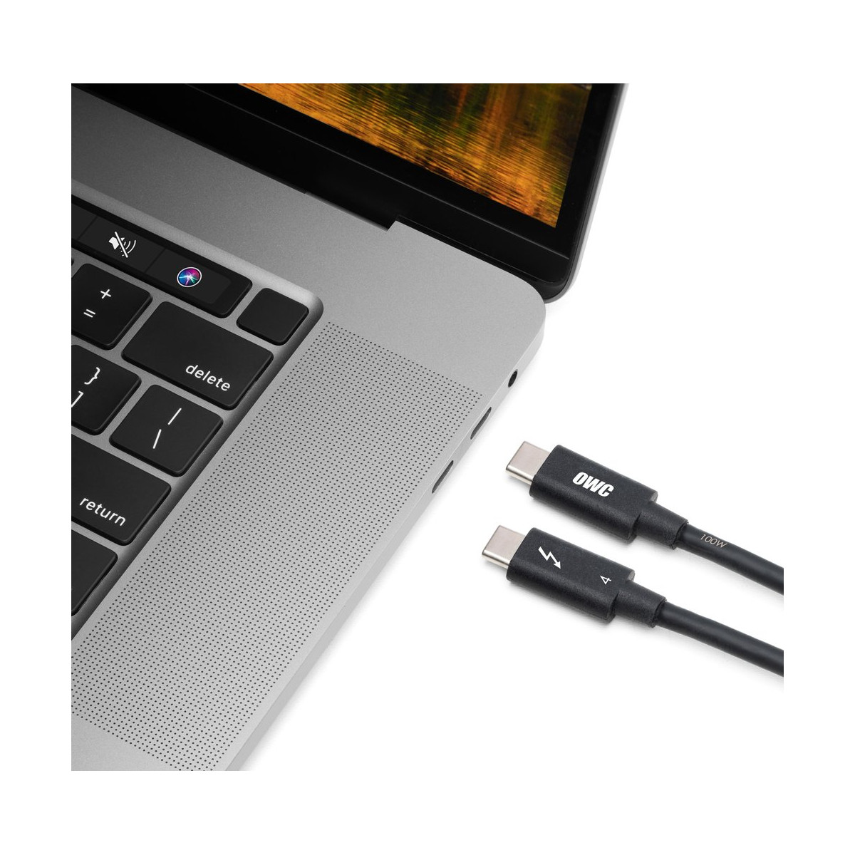 A laptop with a USB-C cable connected, next to another USB-C cable.