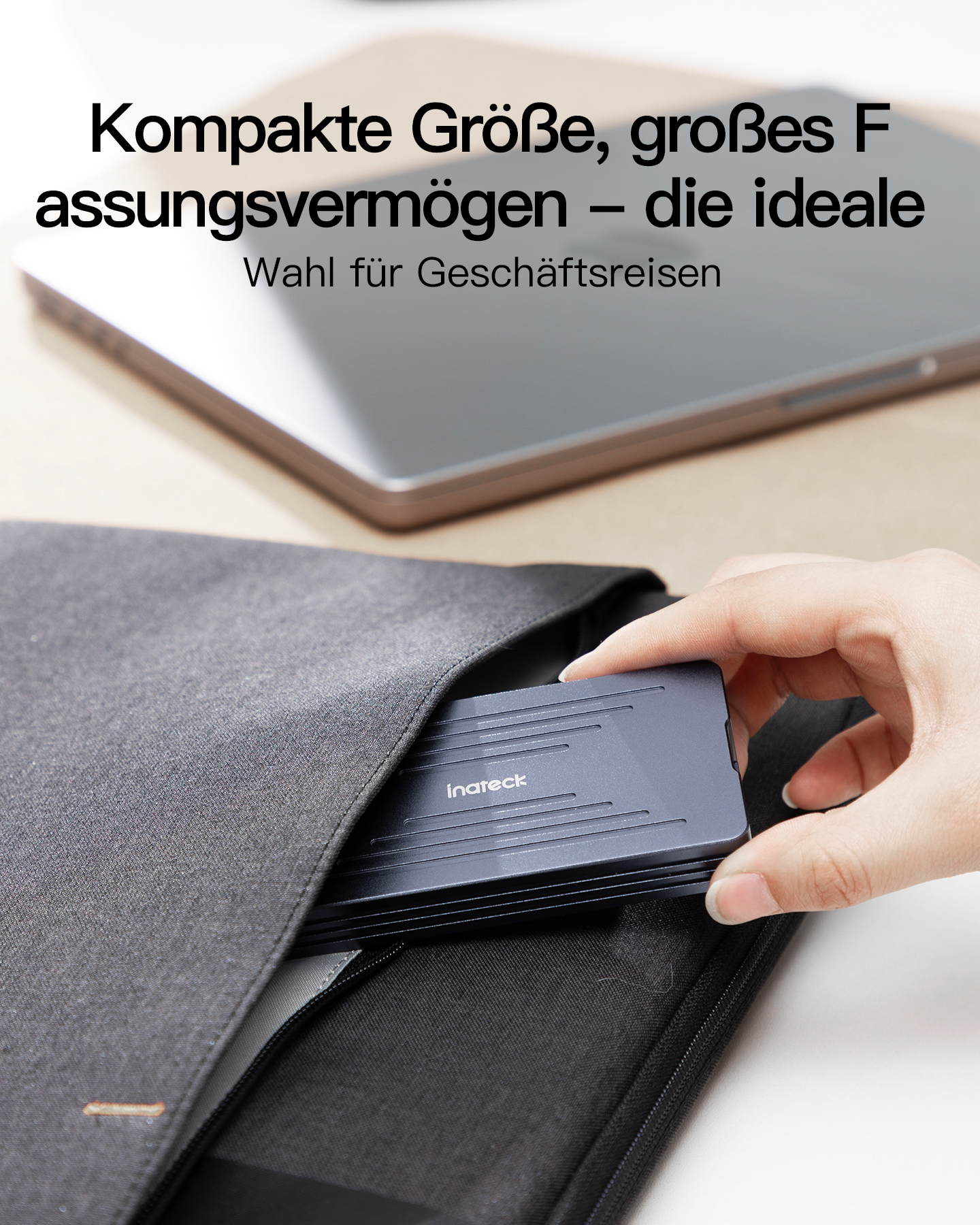 Hand zieht eine kleine graue externe Festplatte aus einer dunkelgrauen Tragetasche.