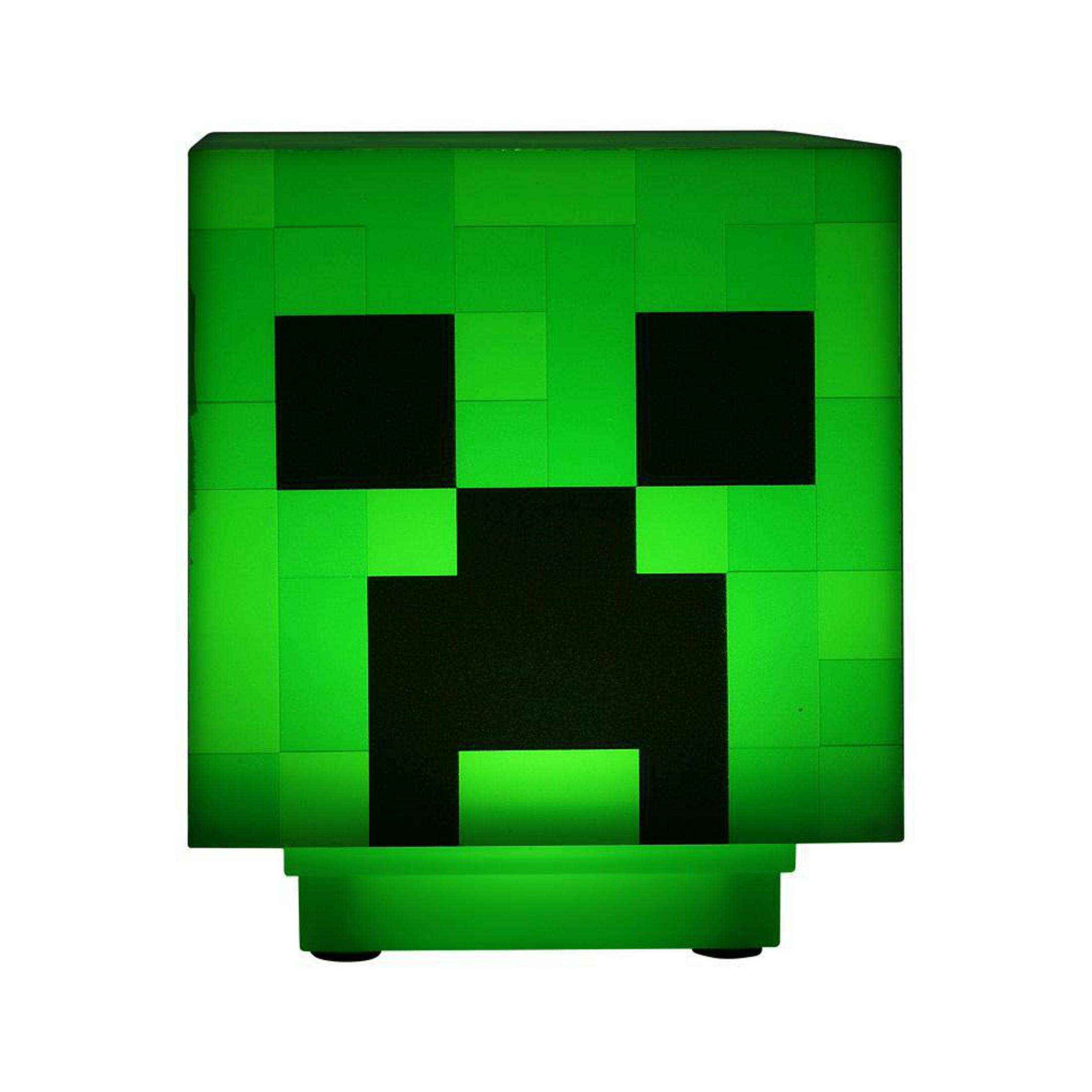 Zielona lampa Minecraft Creeper, z czarnymi oczami i ustami, w kwadratowym kształcie.