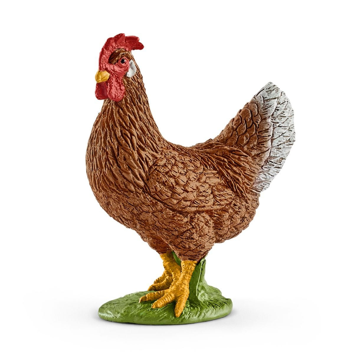 Ein Spielzeug-Huhn. Es ist braun mit rotem Kamm und gelben Füßen. Es steht auf einer grünen Oberfl äche.