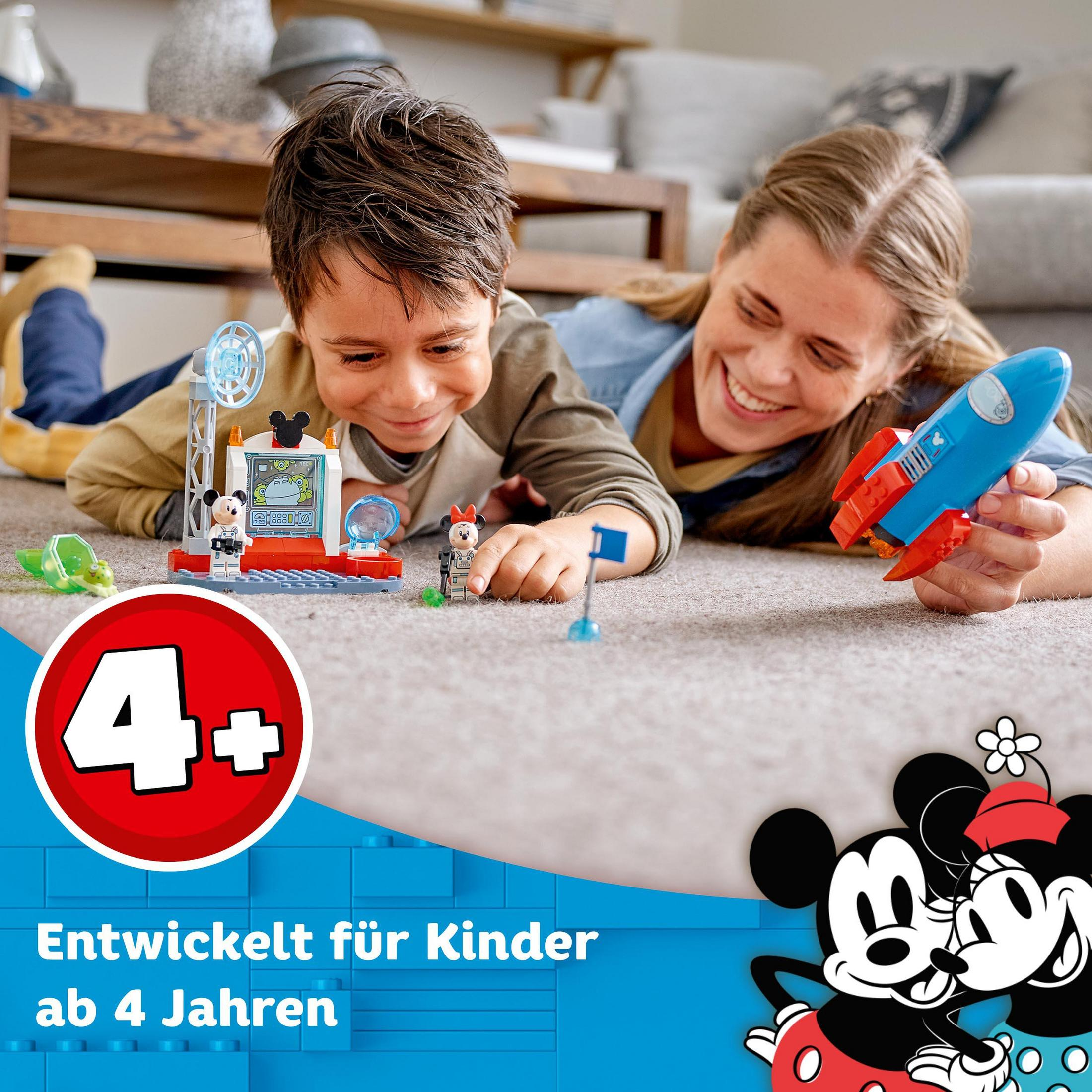 Ein Junge und eine Frau spielen mit einem Mickey Mouse LEGO-Set. Das Set und eine Rakete sind sichtbar.