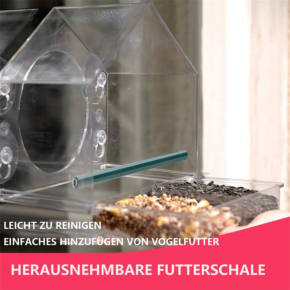 Transparenter Vogelfutterspender mit Futter. Text: Leicht zu reinigen, Vogelfutter einfach hinzufügen, herausnehmbare Futterschale.
