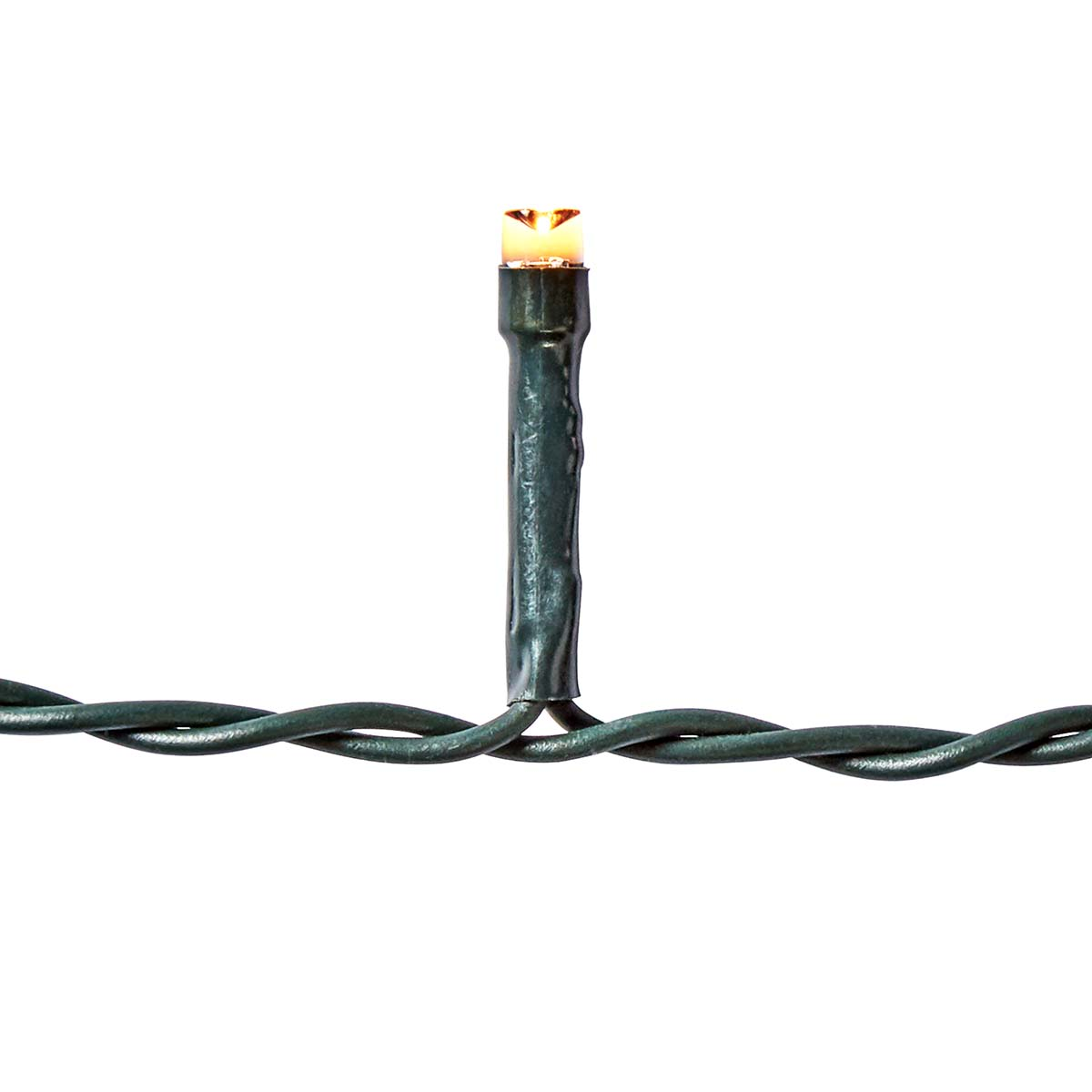 Close-up of a Christmas light. The wire is green, the bulb is clear and orange.