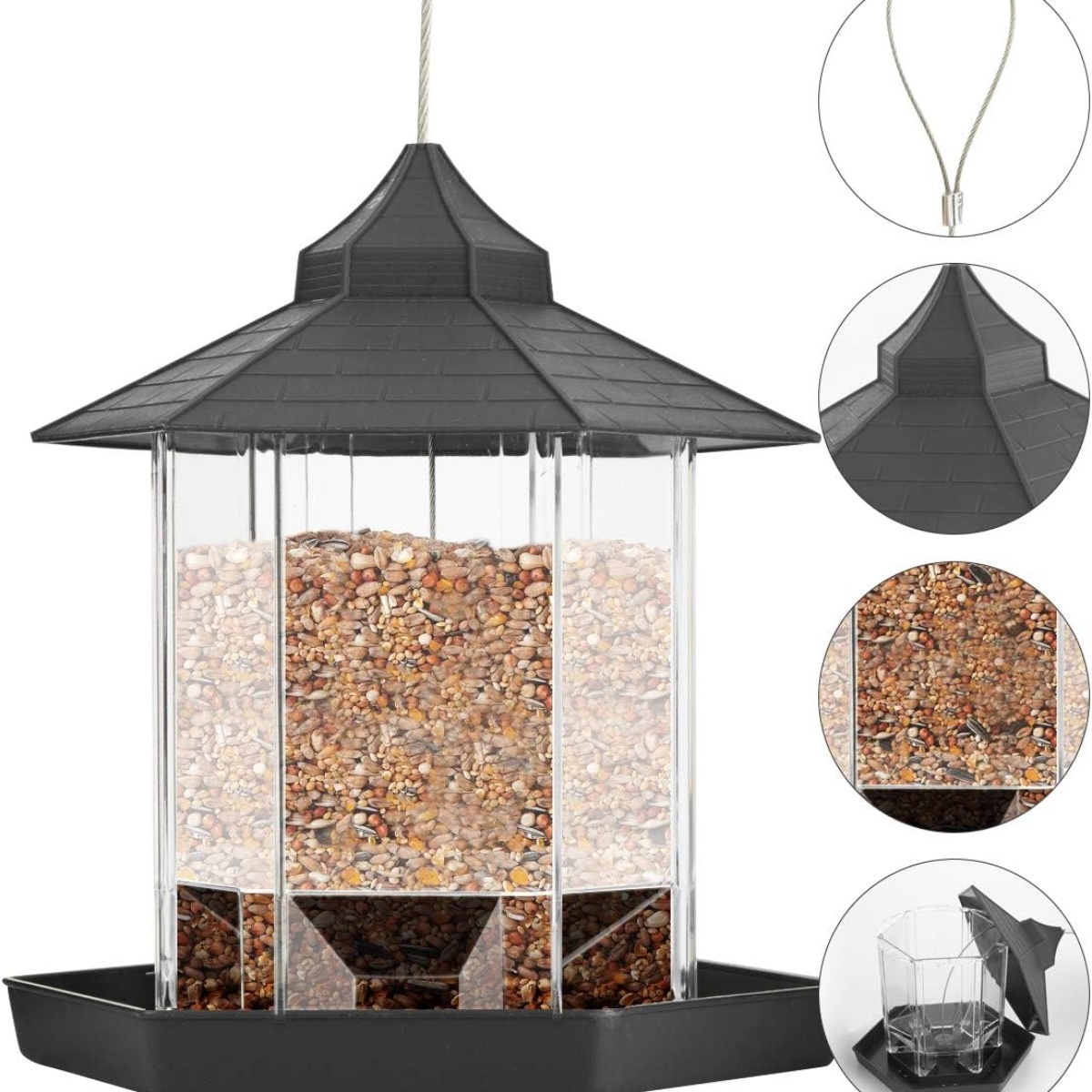Ein Vogelfutterhaus mit schwarzem Dach und transparentem Behälter mit Vogelfutter.