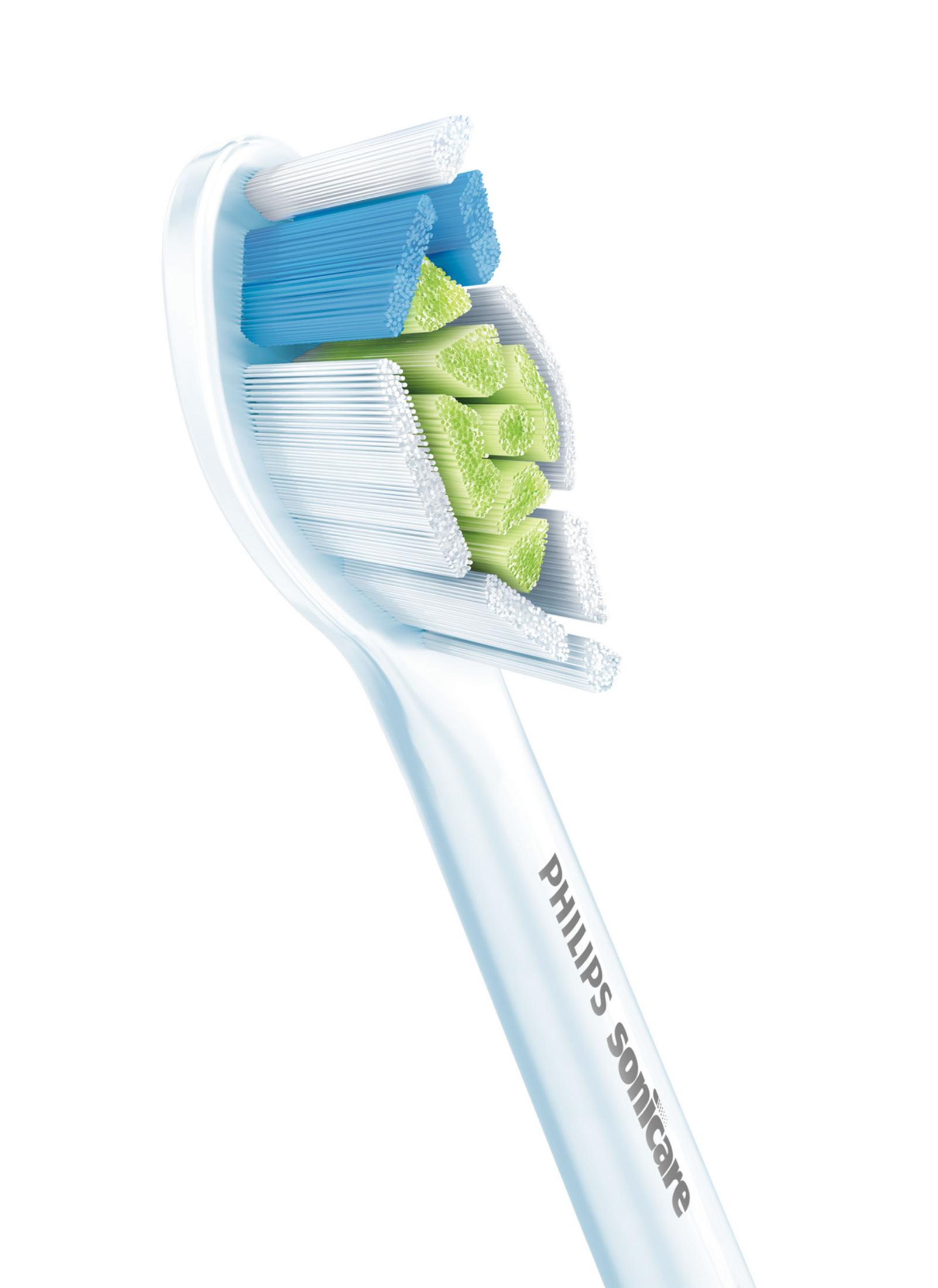 Zbliżenie białej główki szczoteczki elektrycznej z zielonym i niebieskim włosiem.