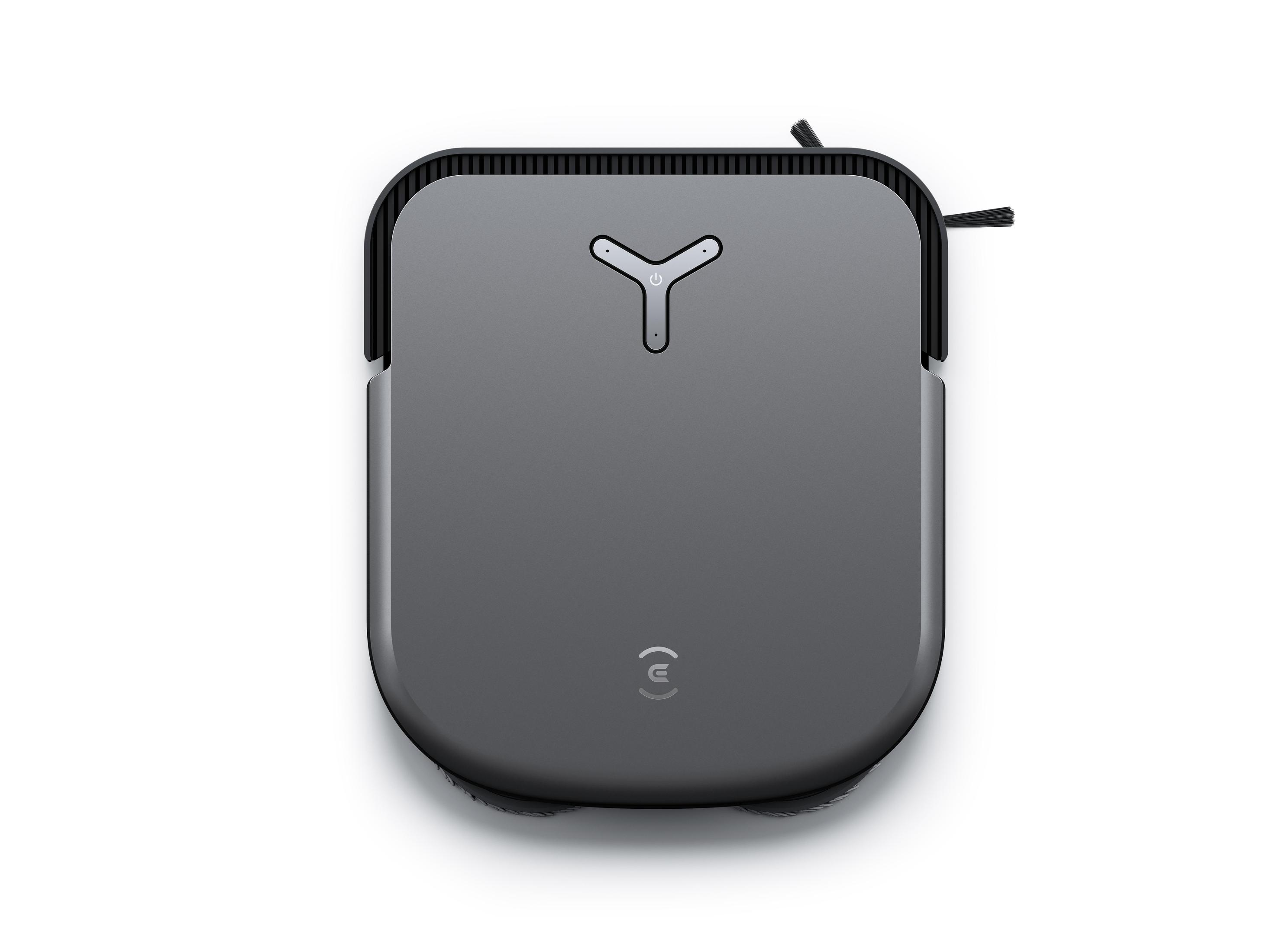 Szary, kwadratowy robot odkurzający na białym tle. Ma przycisk zasilania.