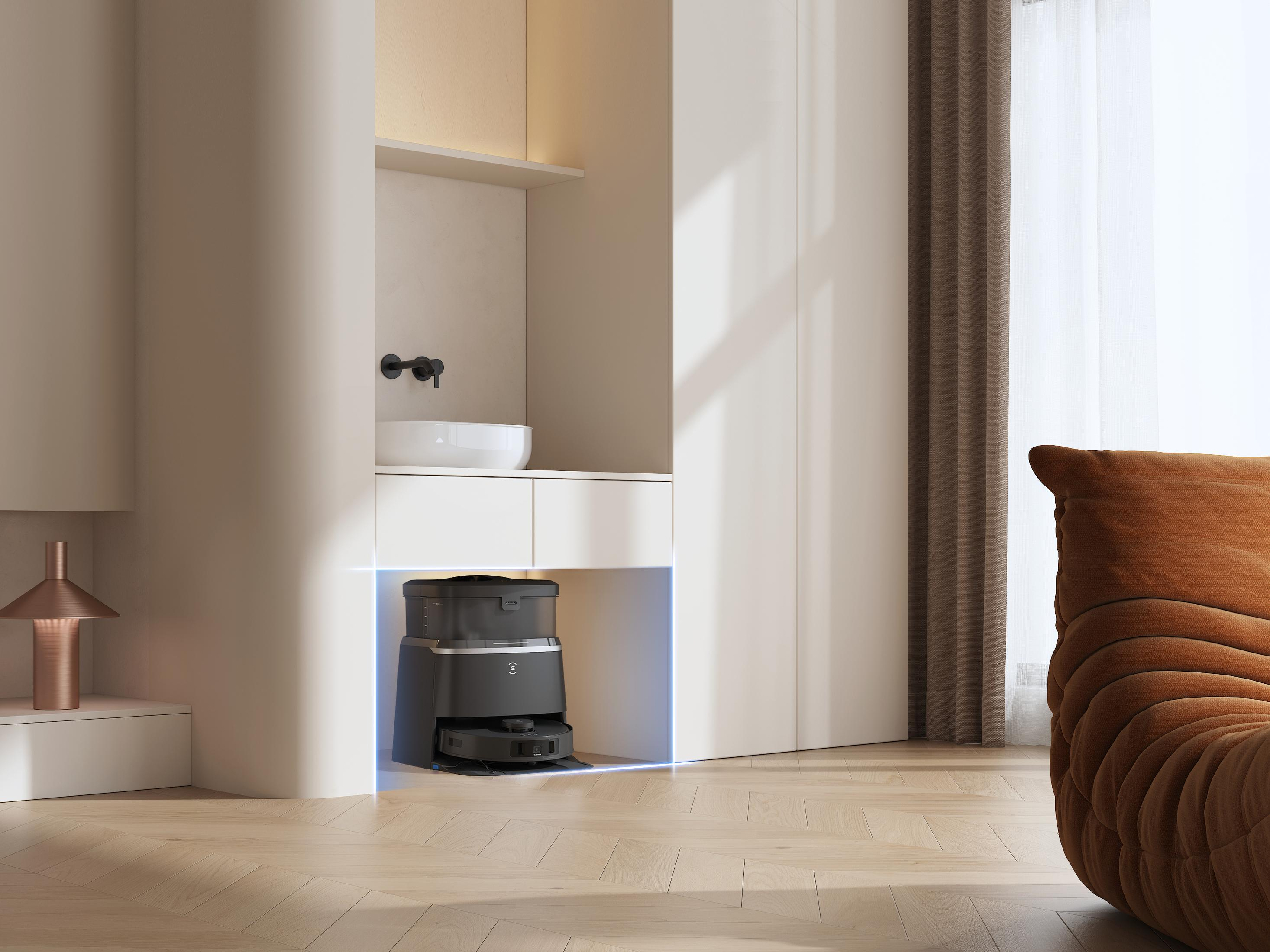 Ein modernes Zimmer mit einem Roboter-Staubsauger in einem Einbauschrank. Ein brauner Stuhl ist sichtbar.