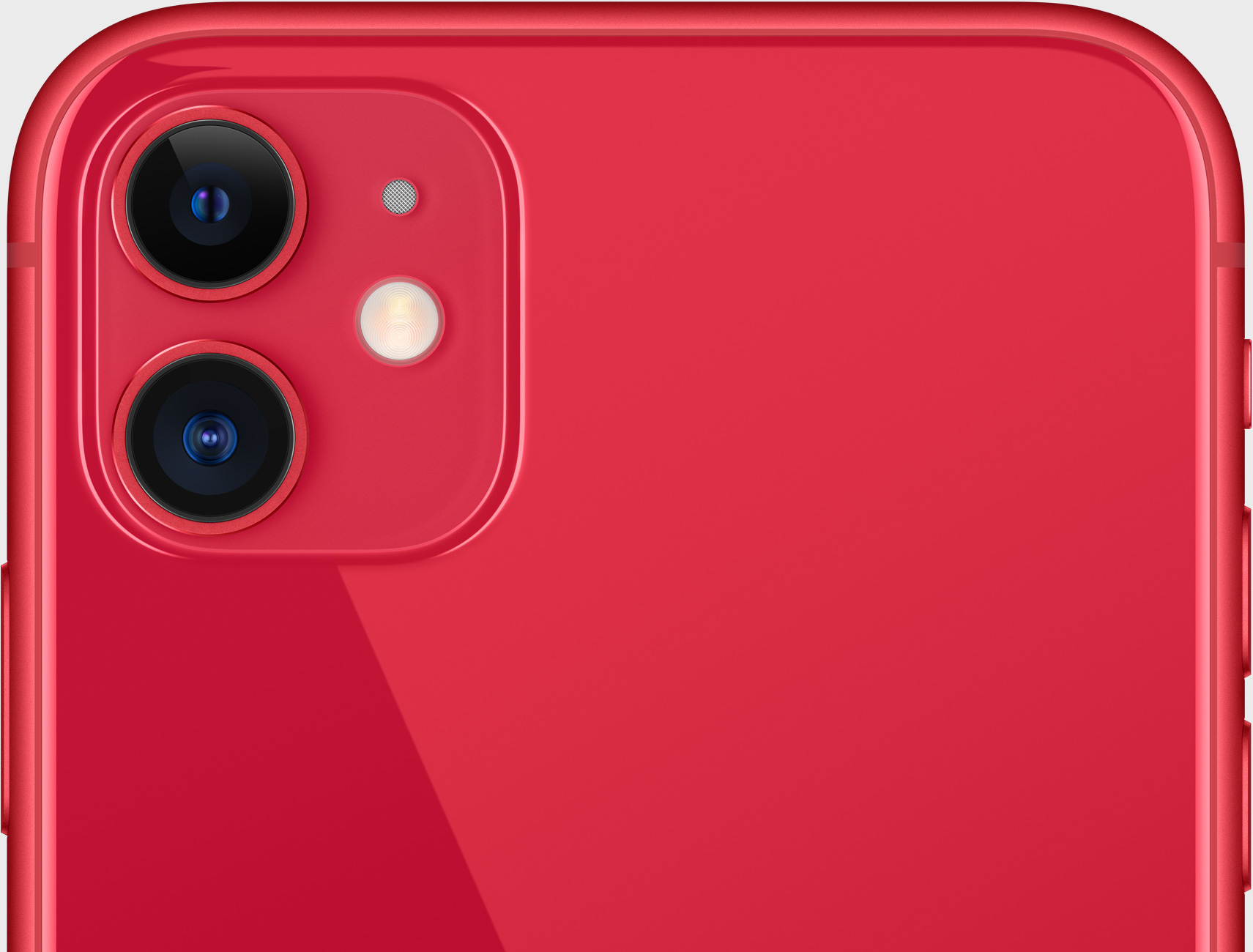 Primo piano di un telefono rosso con due fotocamere e un'unità flash sul retro.