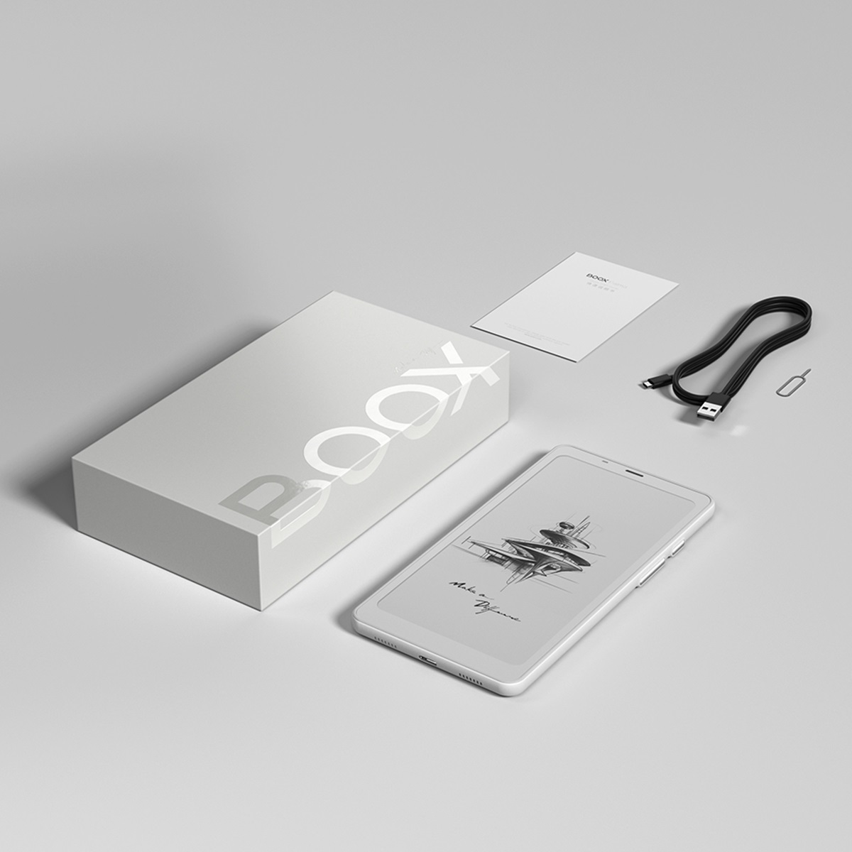 Czytnik e-booków i pudełko z akcesoriami na białej powierzchni.