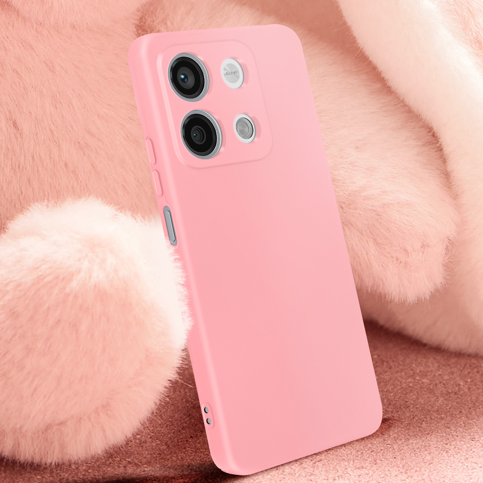Custodia rosa per telefono con fotocamera, su un orsacchiotto rosa di peluche.