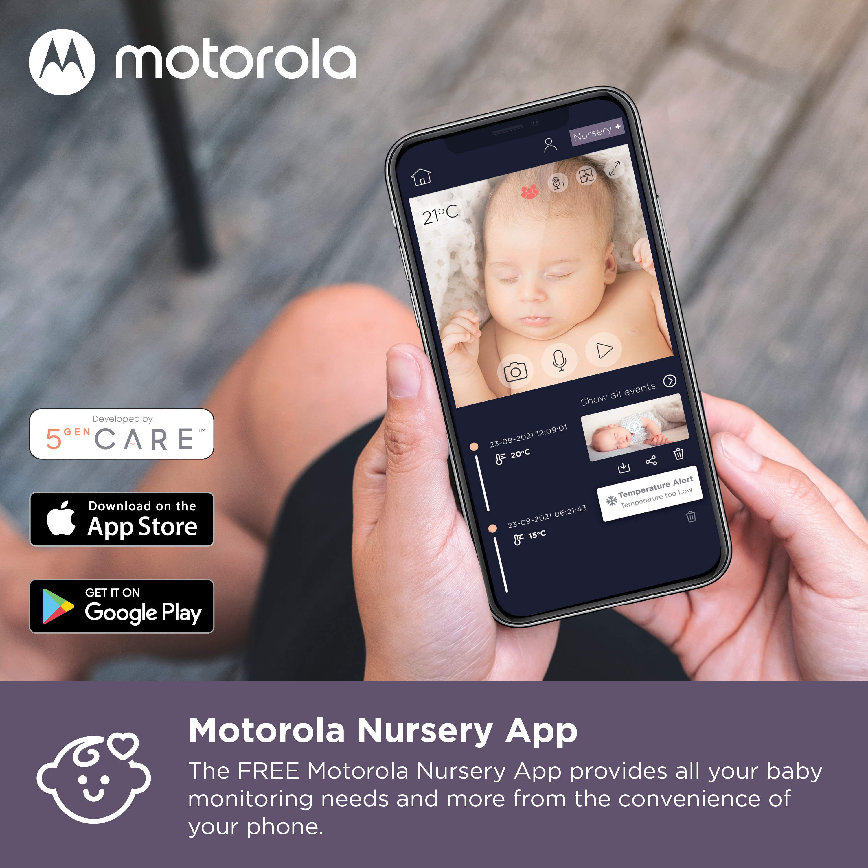 Ein Smartphone zeigt eine Babyphone-App mit einem Baby im Kinderzimmer. App zeigt Temperaturwarnung.