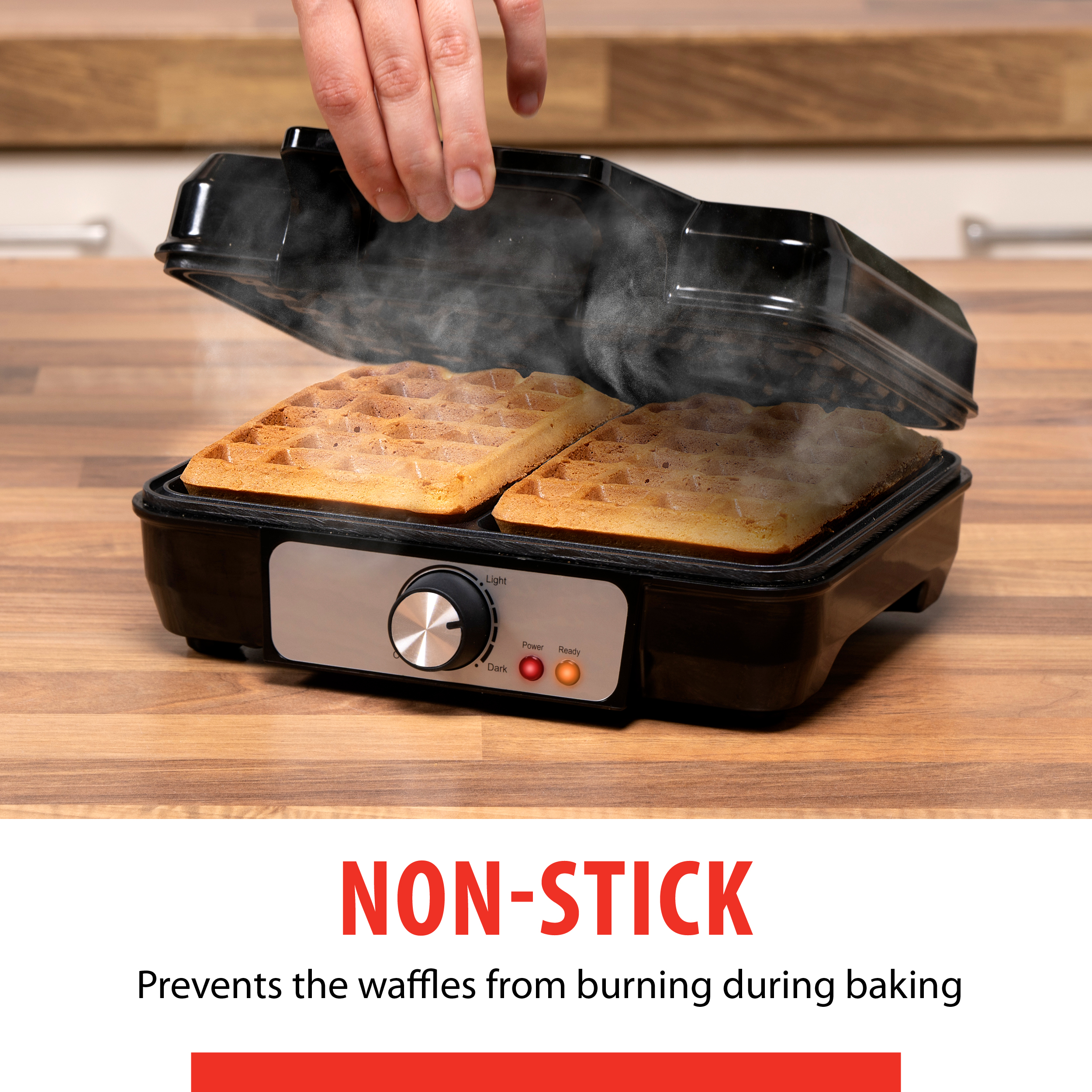 Waffle iron with two waffles inside. Steam is rising. The text reads: NON-STICK.