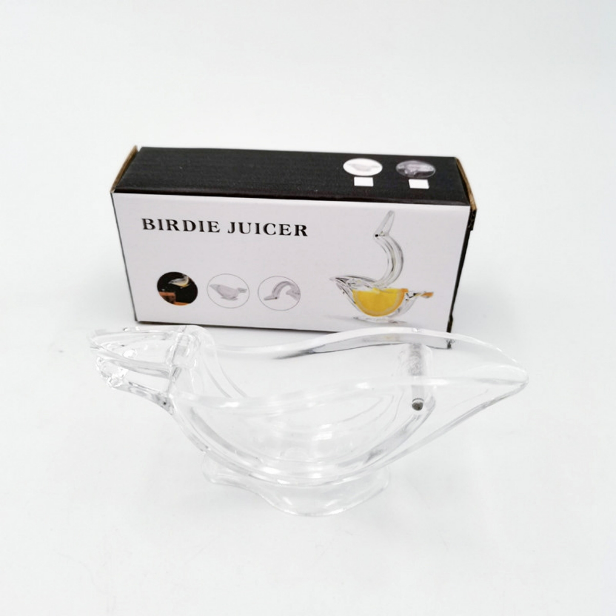 Transparenter, vogelartiger Entsafter mit Box "Birdie Juicer" auf weißem Hintergrund.