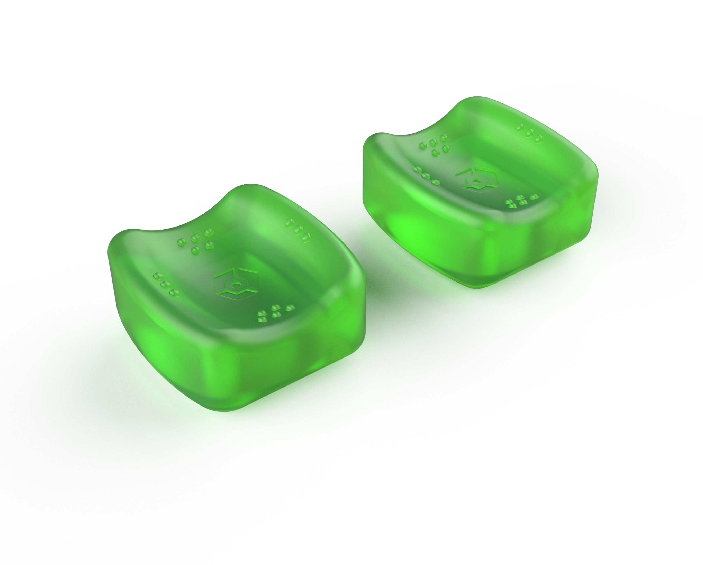 Dos almohadillas de gel verdes y curvas sobre una superficie blanca.