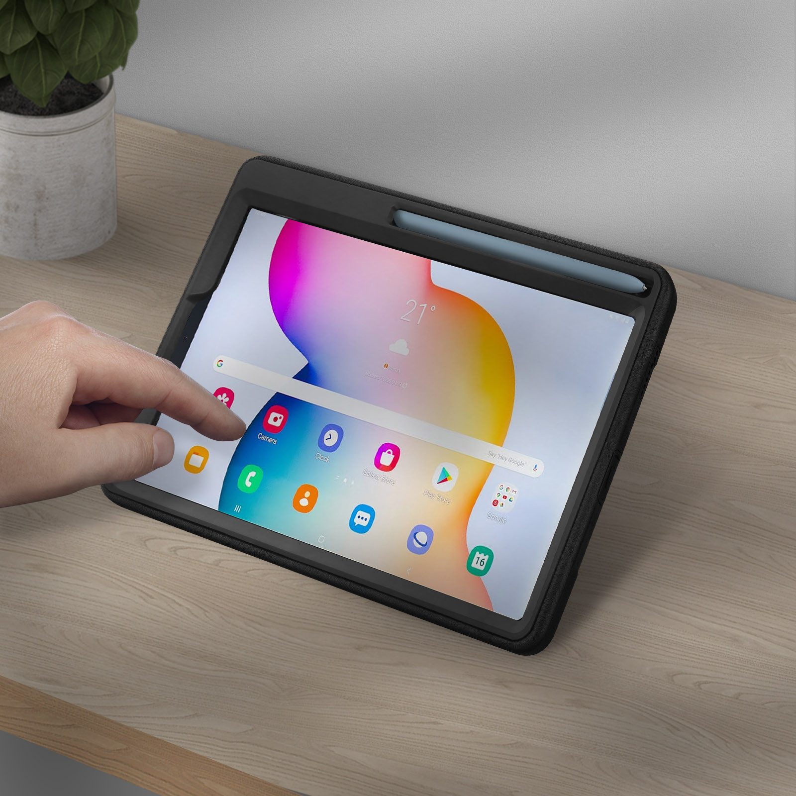 Ein Tablet auf einem Holztisch, eine Hand berührt den Bildschirm.