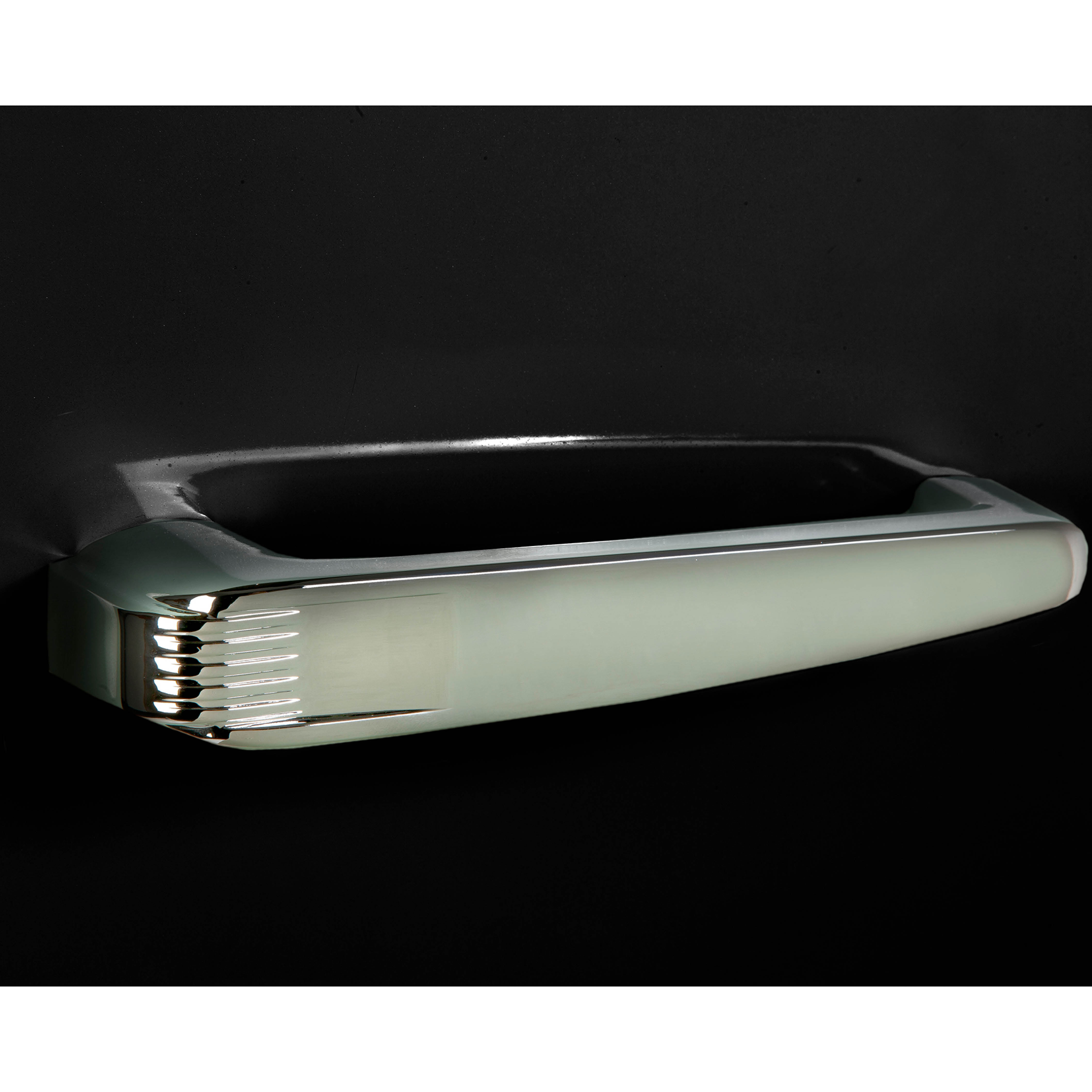 Silver refrigerator handle on black background. The handle is slightly reflective.