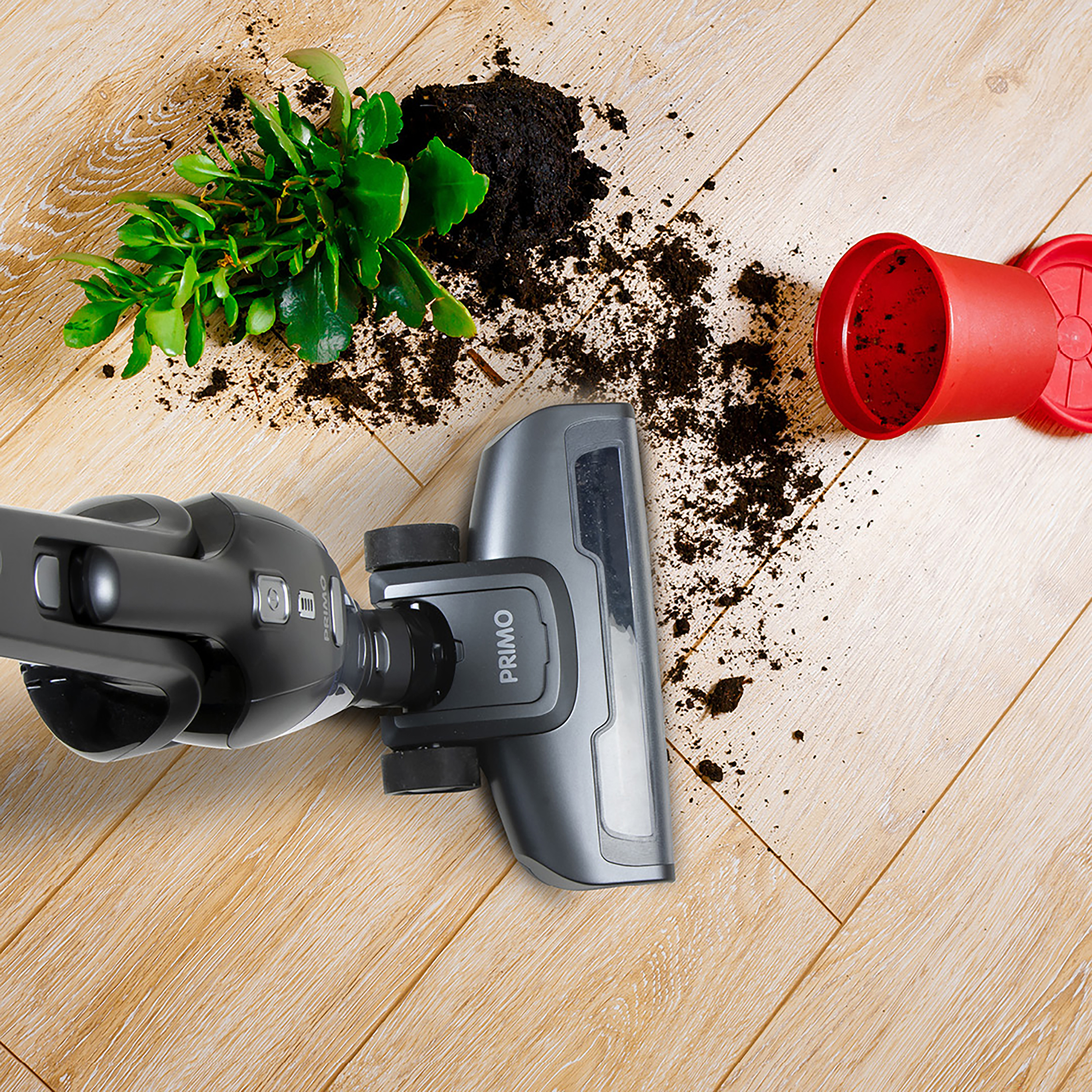 Vacuum cleaner head cleaning soil and a spilled pot.