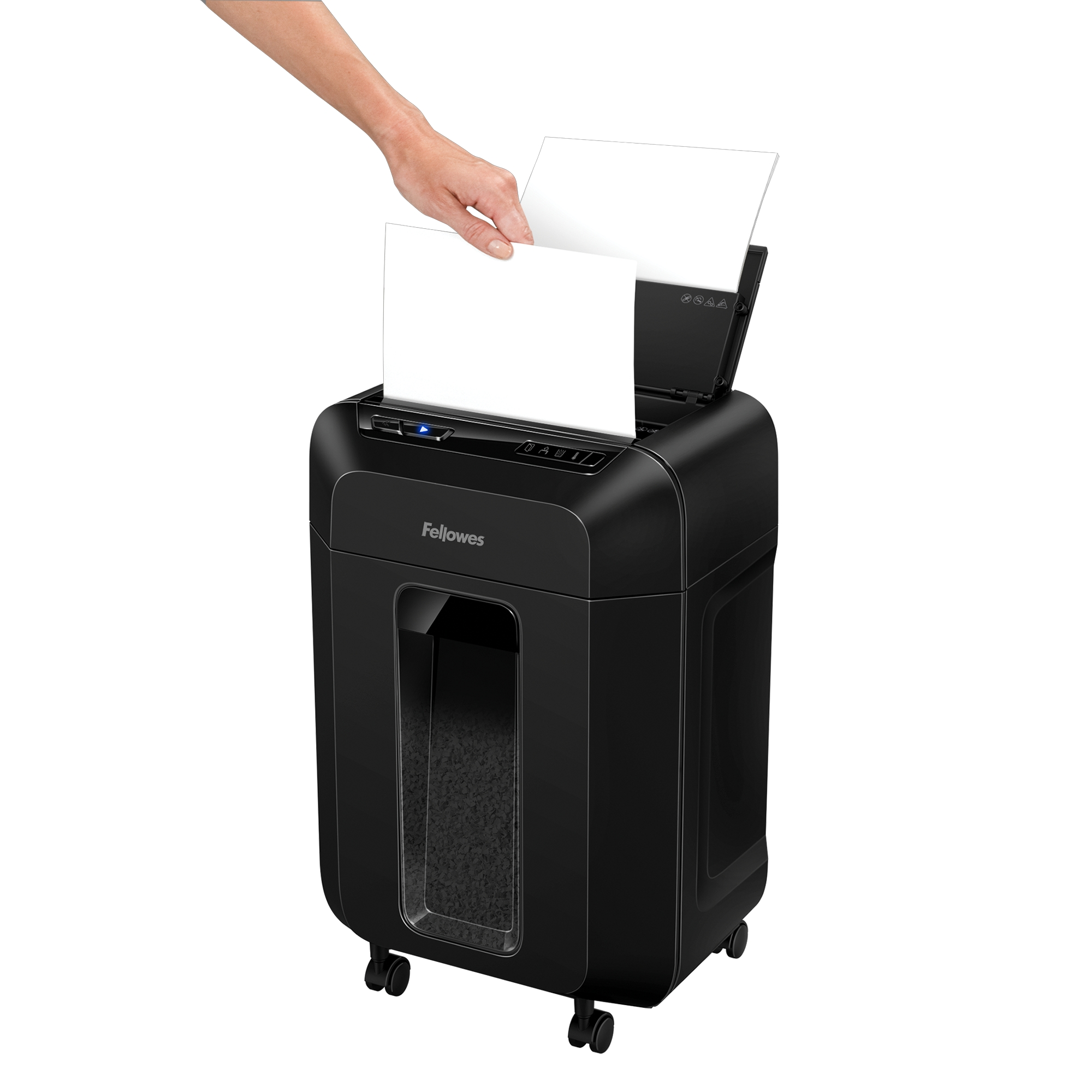A person feeding white paper into a black paper shredder. Fellowes brand is visible.