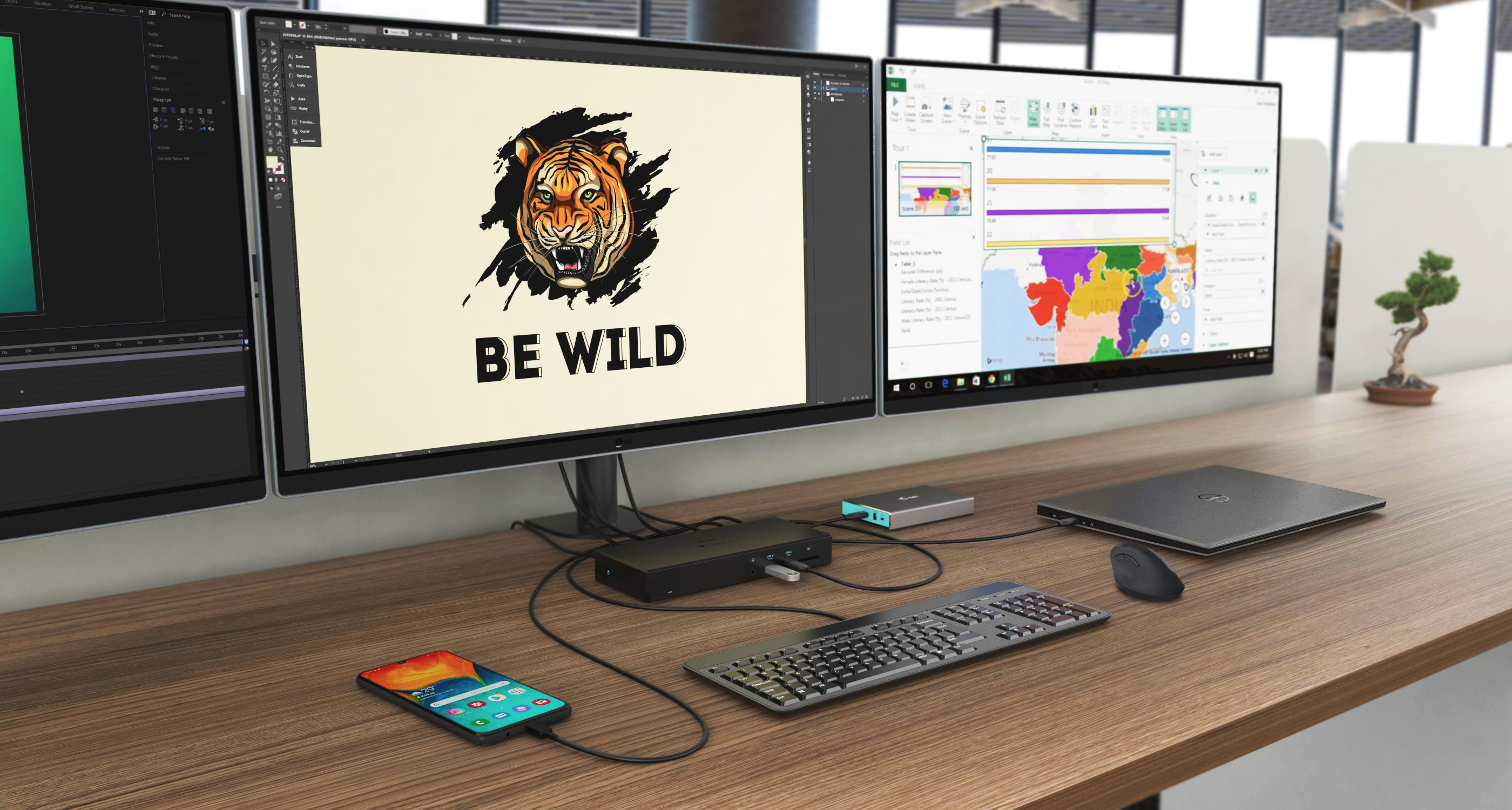 Un escritorio con monitores que muestran gráficos y datos, un teclado, un teléfono y una computadora portátil.