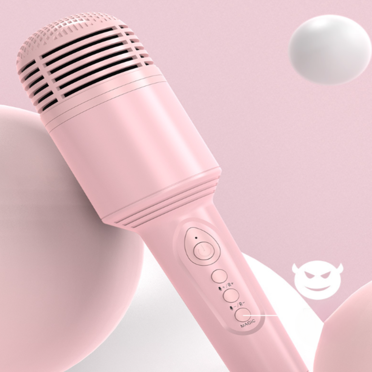 Rosa Mikrofon mit Knöpfen und einem Gitter. Zwei weiße Kugeln und ein Teufel-Emoji im Hintergrund.