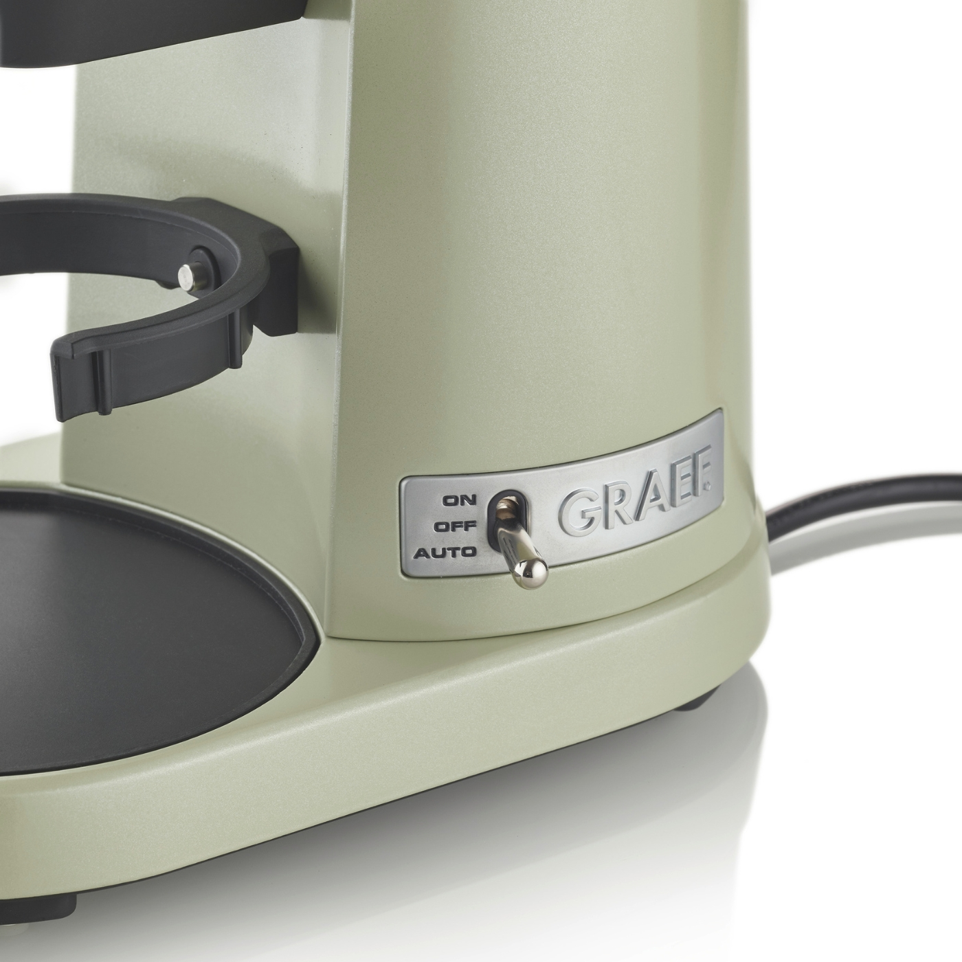 Una macchina per il caffè verde con un interruttore e un supporto per una tazza.