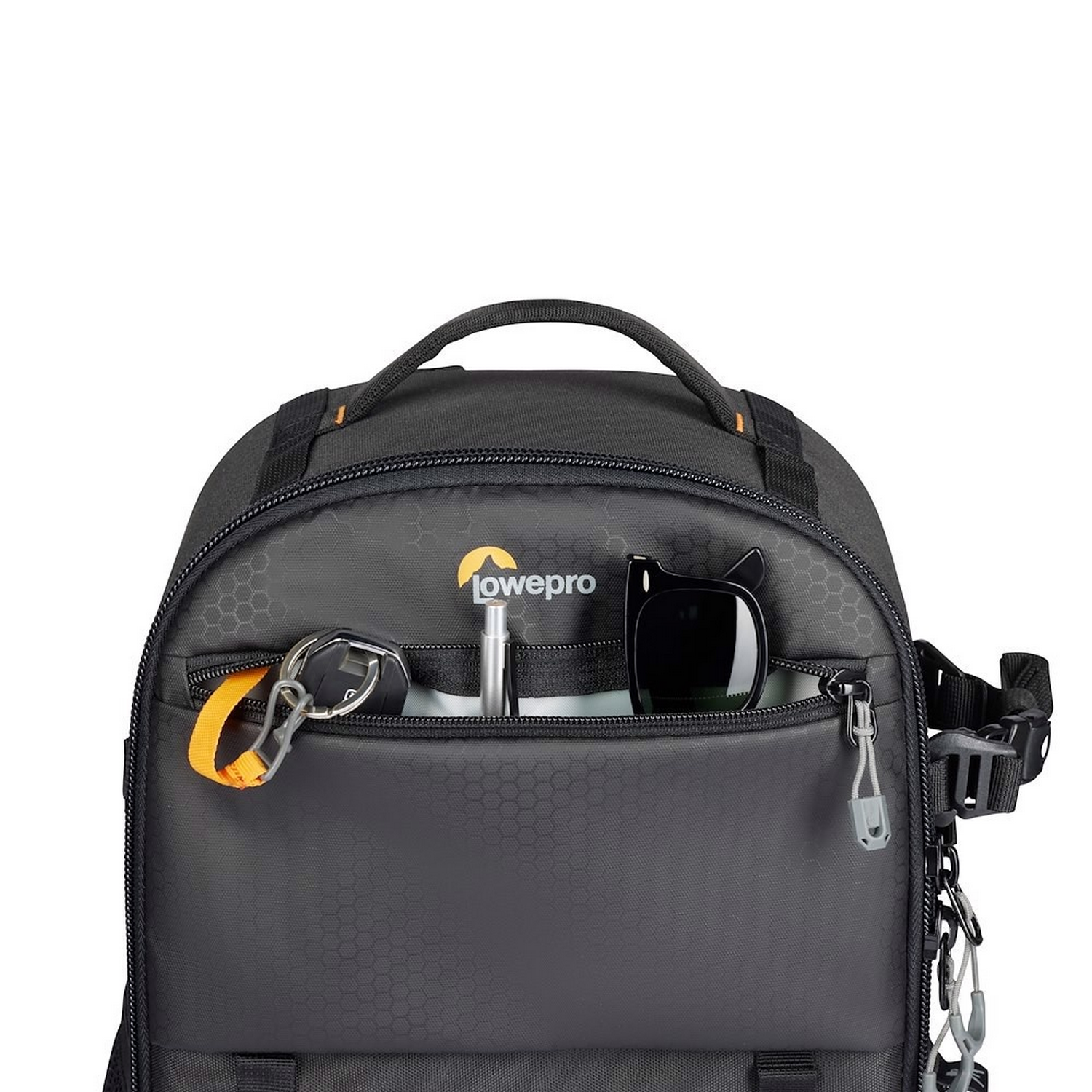 Black Lowepro camera bag open, revealing contents. Keys, pen, and sunglasses are visible.